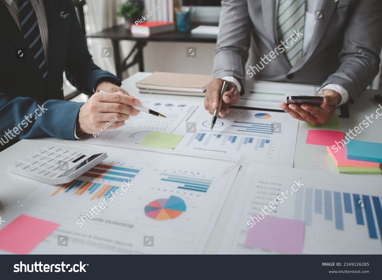 Atmosphere of a startup company meeting, business people are meeting together to summarize and plan investment finances, they are the founders of the company. Business administration concept. #2349126285