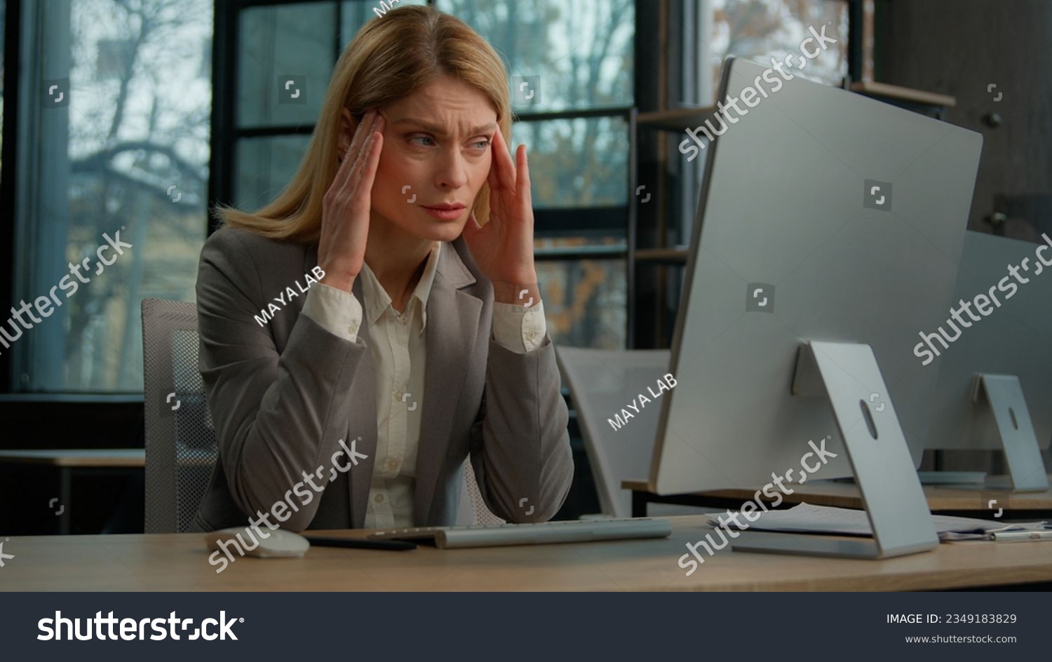 Sick ill sad Caucasian middle-aged adult woman mature business lady businesswoman worker employer in office with computer suffer with headache pain ache painful head stress migraine pressure sickness #2349183829