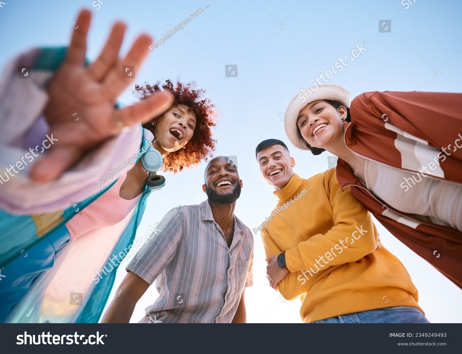 Portrait, smile and a group of friends on a blue sky outdoor together for freedom, bonding or fun from below. Diversity, travel or summer with happy men and women laughing outside on vacation #2349249493
