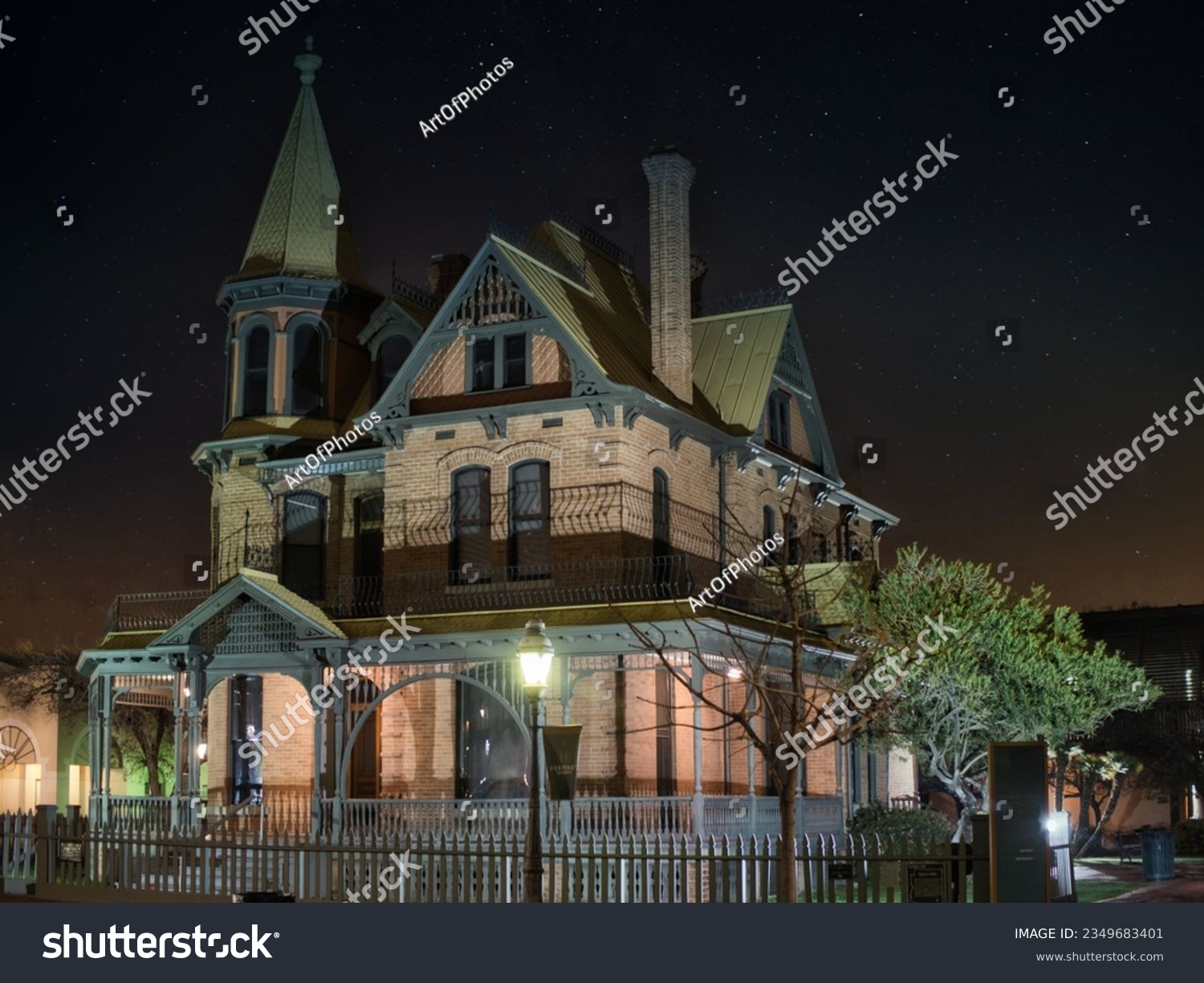 Photo of a beautifully illuminated Victorian house at night #2349683401