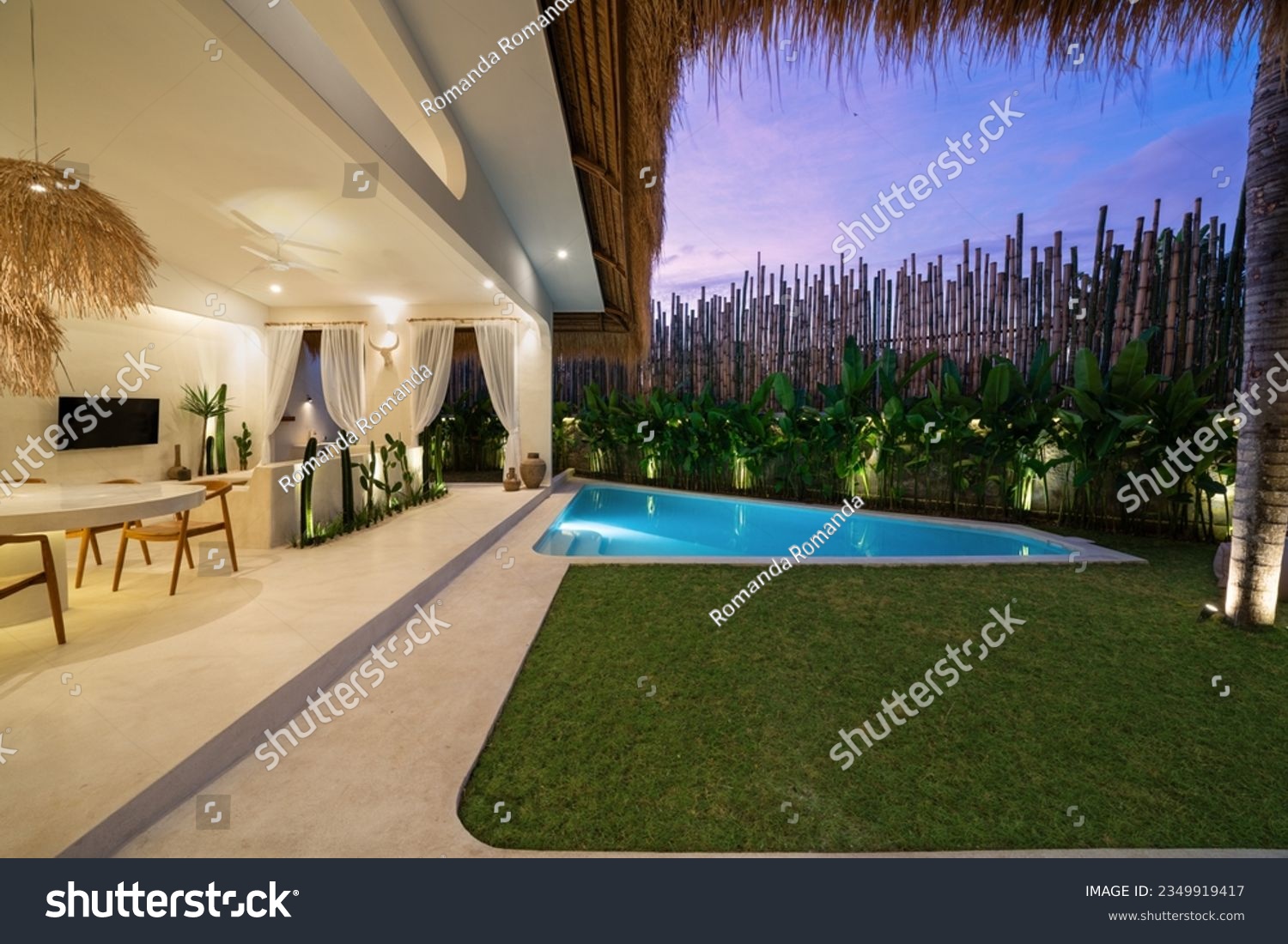 Tropical villa view with garden, swimming pool and open living room at sunset. #2349919417
