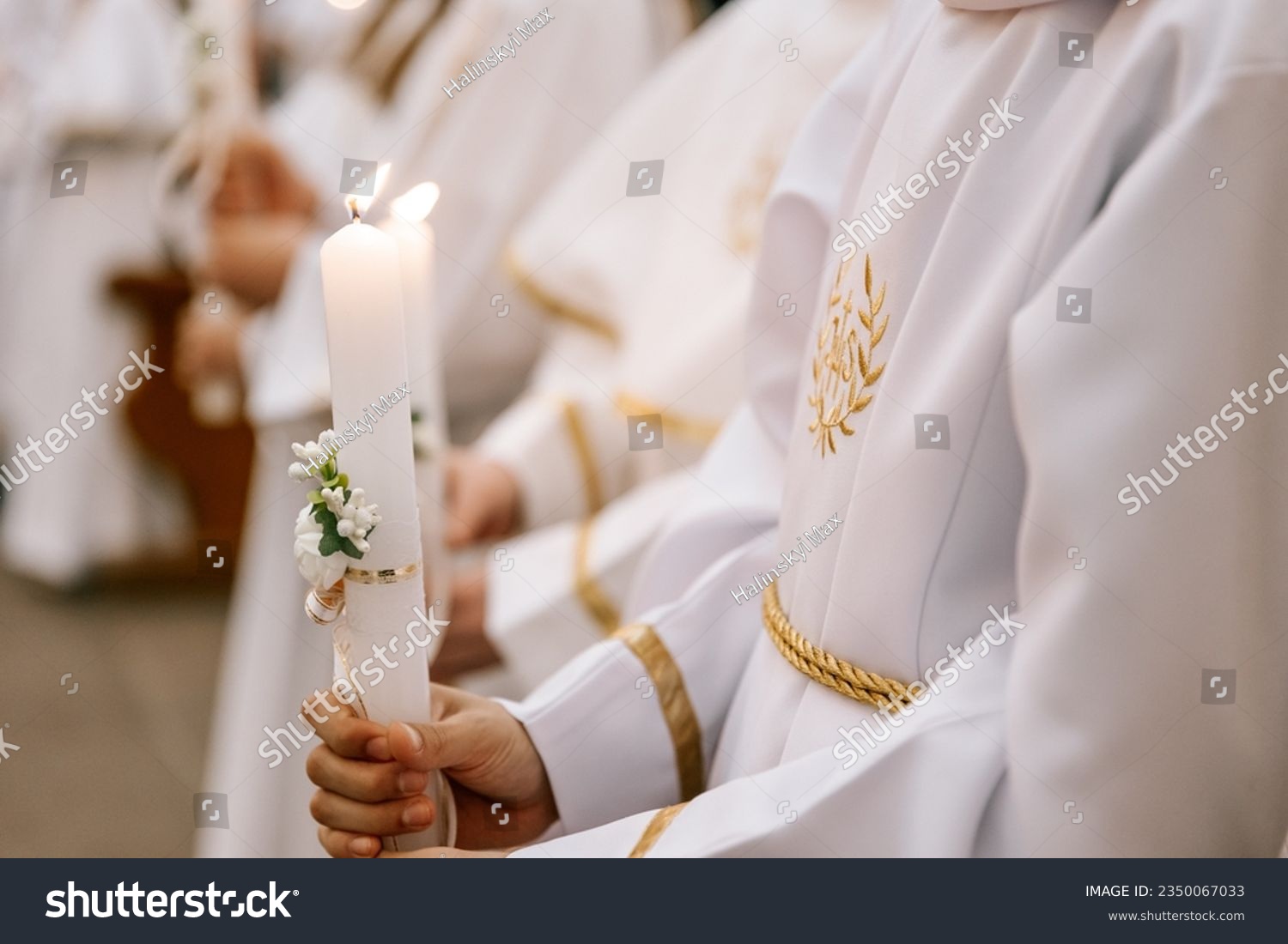 photo of children's hands receiving their first communion in a Catholic church, the priest blesses them #2350067033