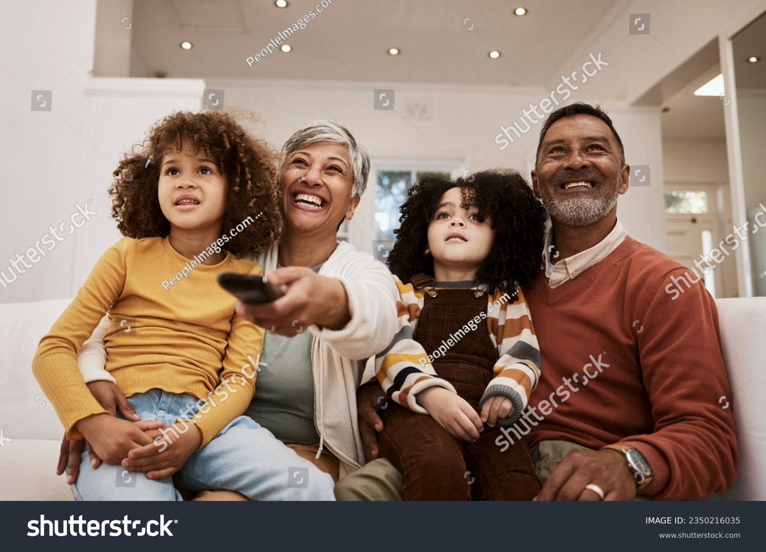 Home, kids and grandparents watch television series, subscription movie or streaming video, media or entertainment. Lounge sofa, family or relax grandmother, grandfather and children watching tv show #2350216035