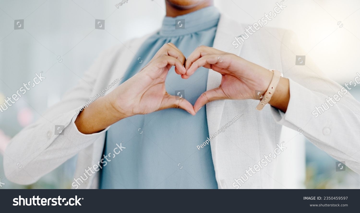 Hands, heart and business woman with love emoji for care, kindness and symbol in office. Closeup of happy female worker with finger shape for thank you, trust and sign of hope, support icon and peace #2350459597