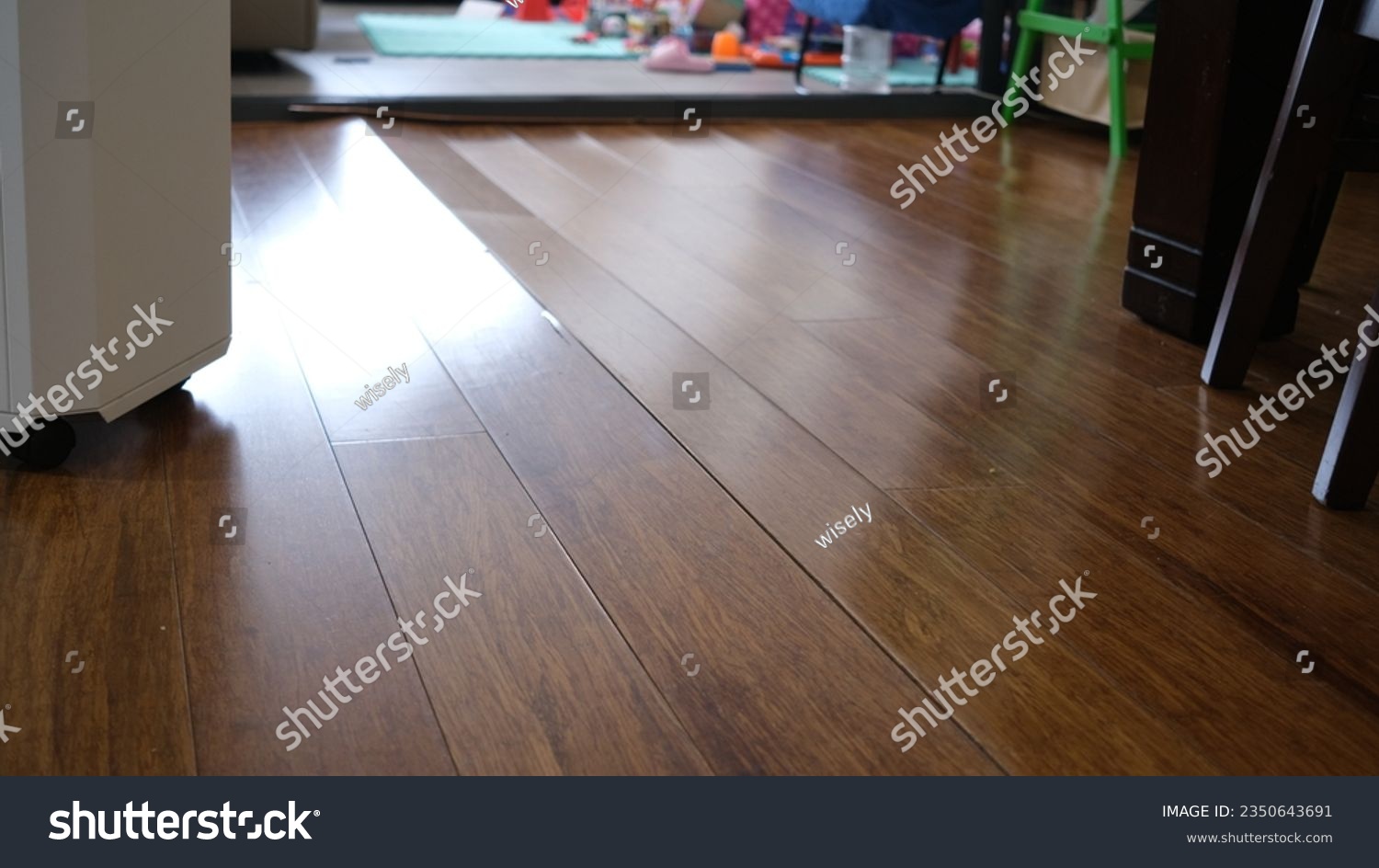 Corrugated wooden floor due to expansion at Living room. #2350643691
