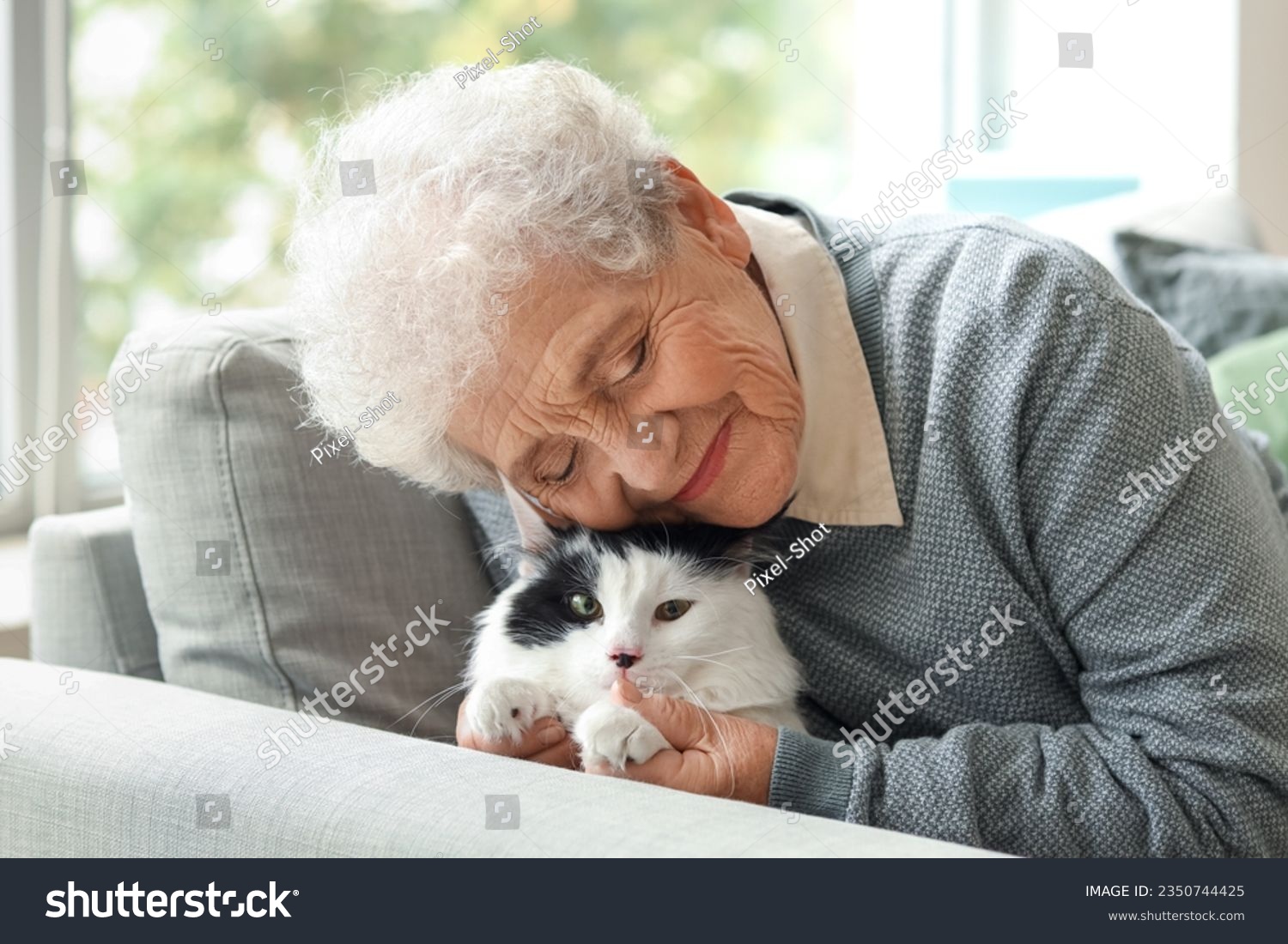 Senior woman with cute cat resting at home #2350744425