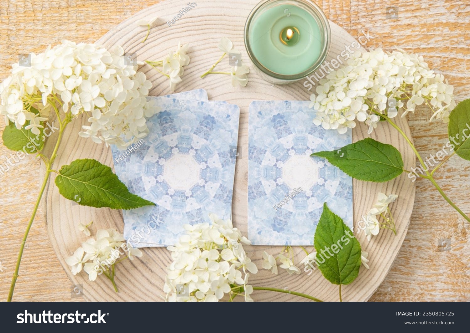 Deck with homemade divination Angel cards on wood table with hydrangea flower for decoration. Home indoors candle burning. #2350805725
