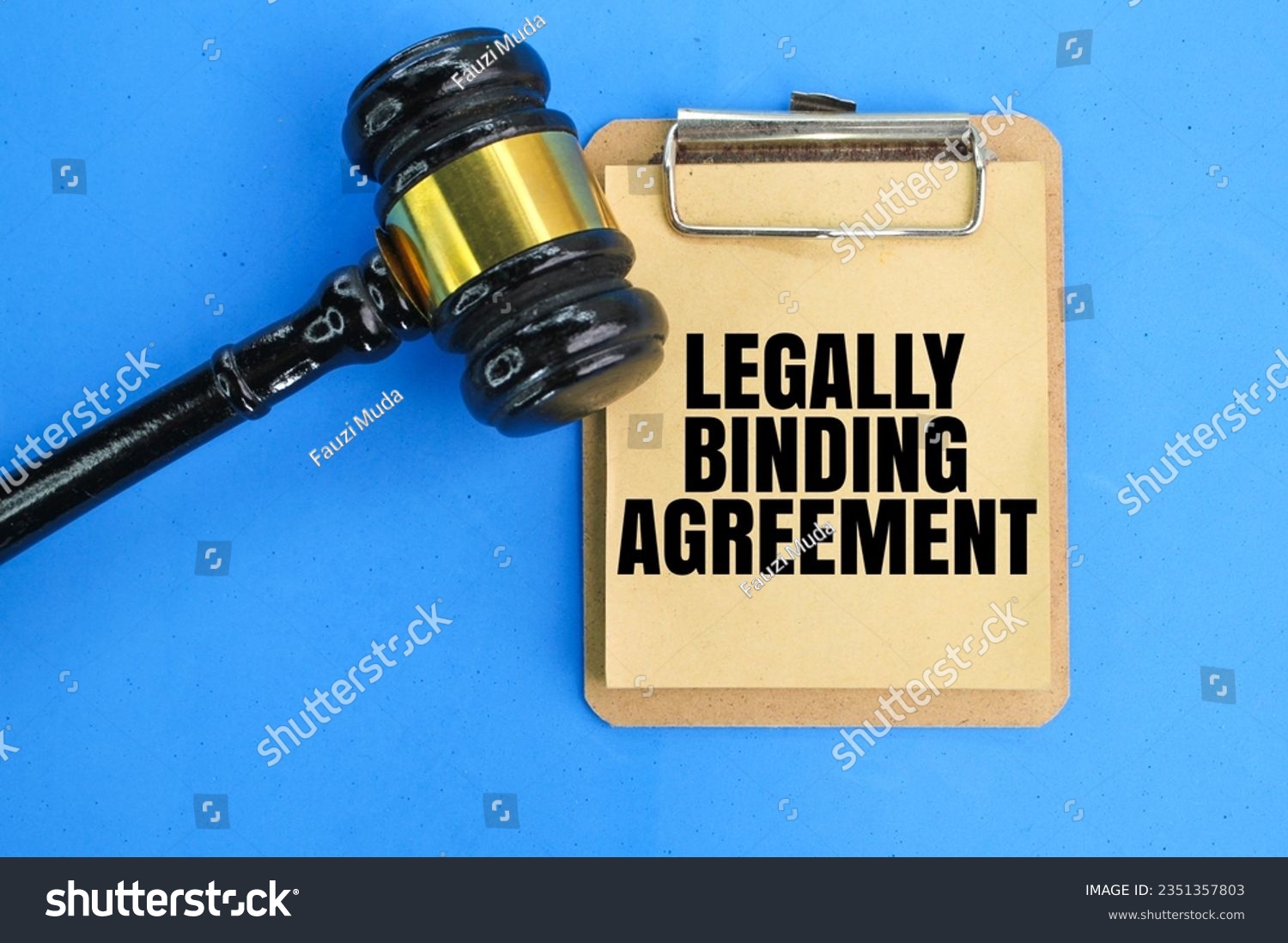 a judge's hammer and a whiteboard with the wording of a legally binding agreement. the concept of mutual consent. #2351357803