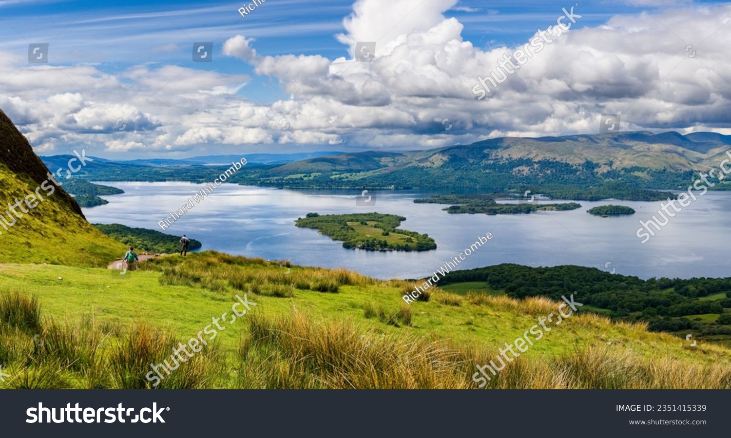 Hikers descending Conic Hill towards Loch Lomond with beautiful mountain scenery (Balmaha) #2351415339