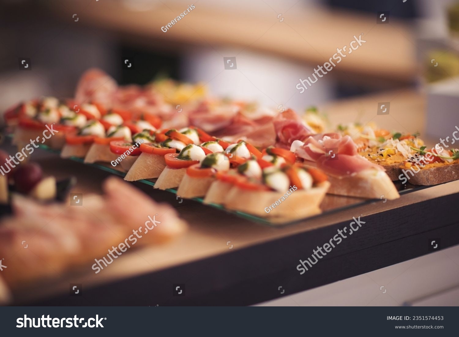 Snacks for the holiday, catering. Various light snacks. Catering plate. Assortment of sandwiches on the buffet table. meat, fish, nuts, cheese, vegetable canapes ofcelebration of important event.  #2351574453