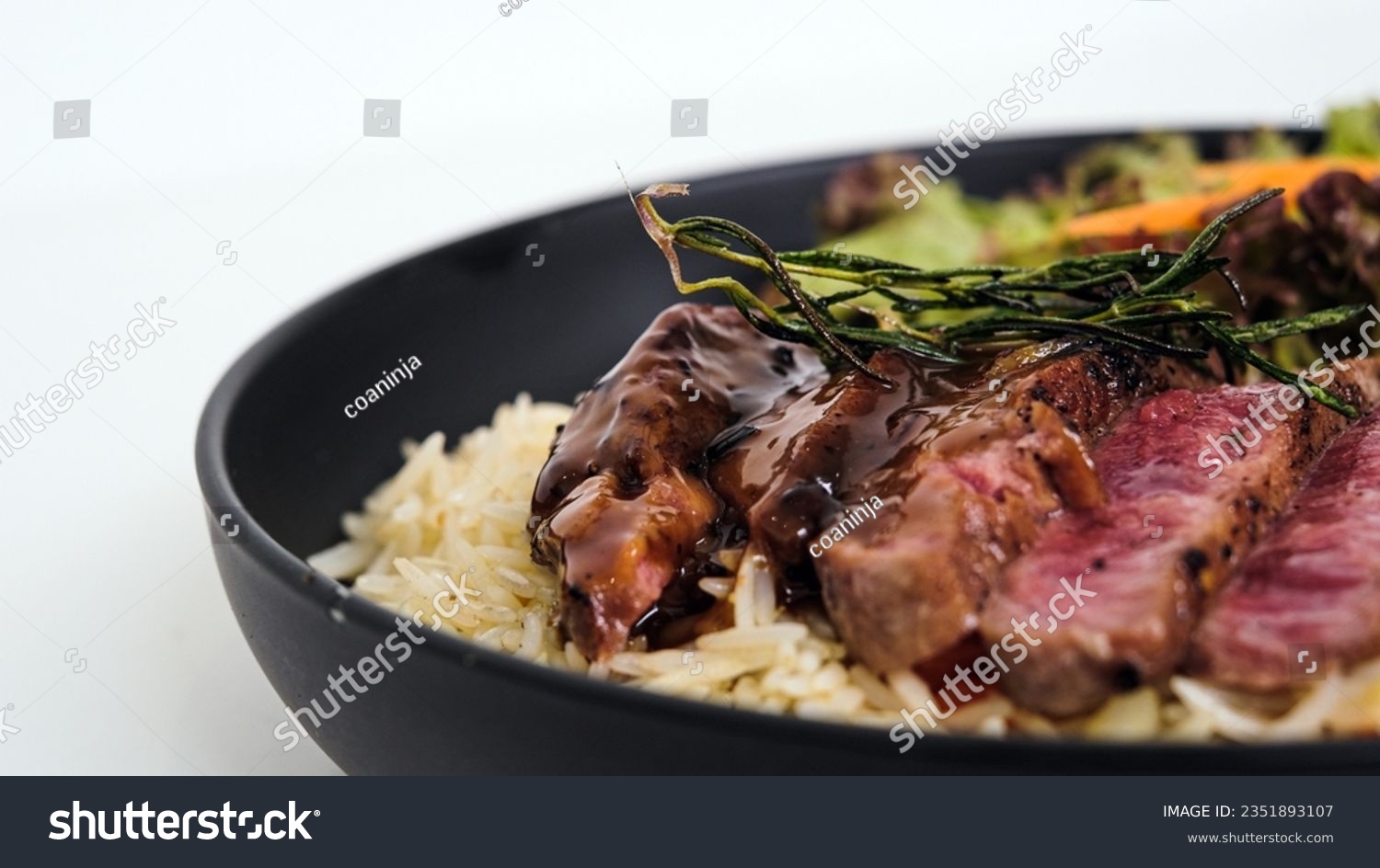 Juicy New York strip beef steak with special sauce, buttery rice, and vegetables #2351893107