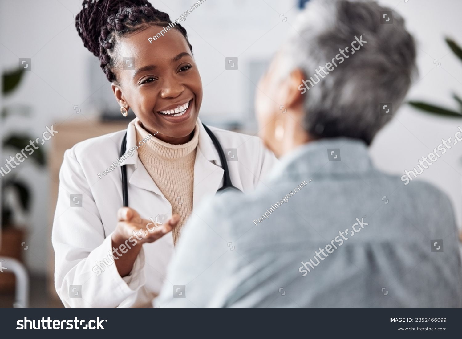 Smile, black woman or doctor consulting a patient in meeting in hospital for healthcare feedback or support. Happy, medical or nurse with a mature person talking or speaking of test results or advice #2352466099