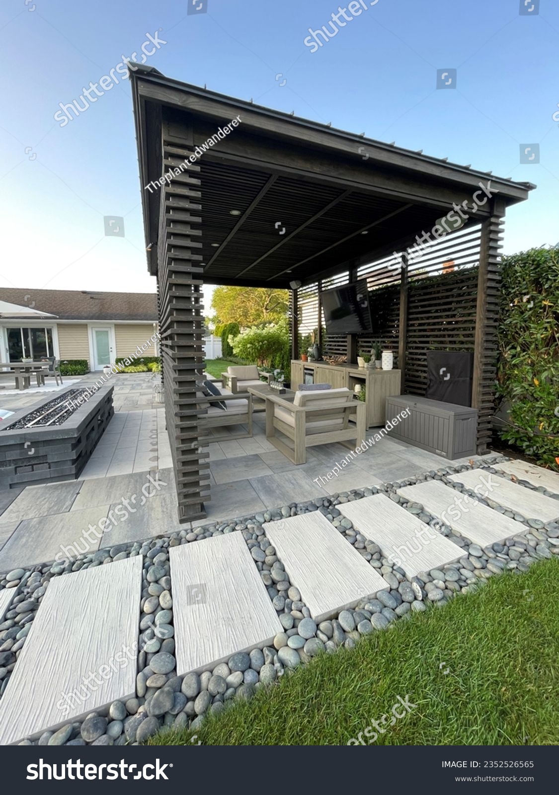 Gorgeous paving stone walkway with gray Mexican pebbles alongside pool and pavilion  pergola with pavers.  Ideal design for modern, luxury backyard living.Inspired by Tulum, Mexico's eco-chic feel. #2352526565