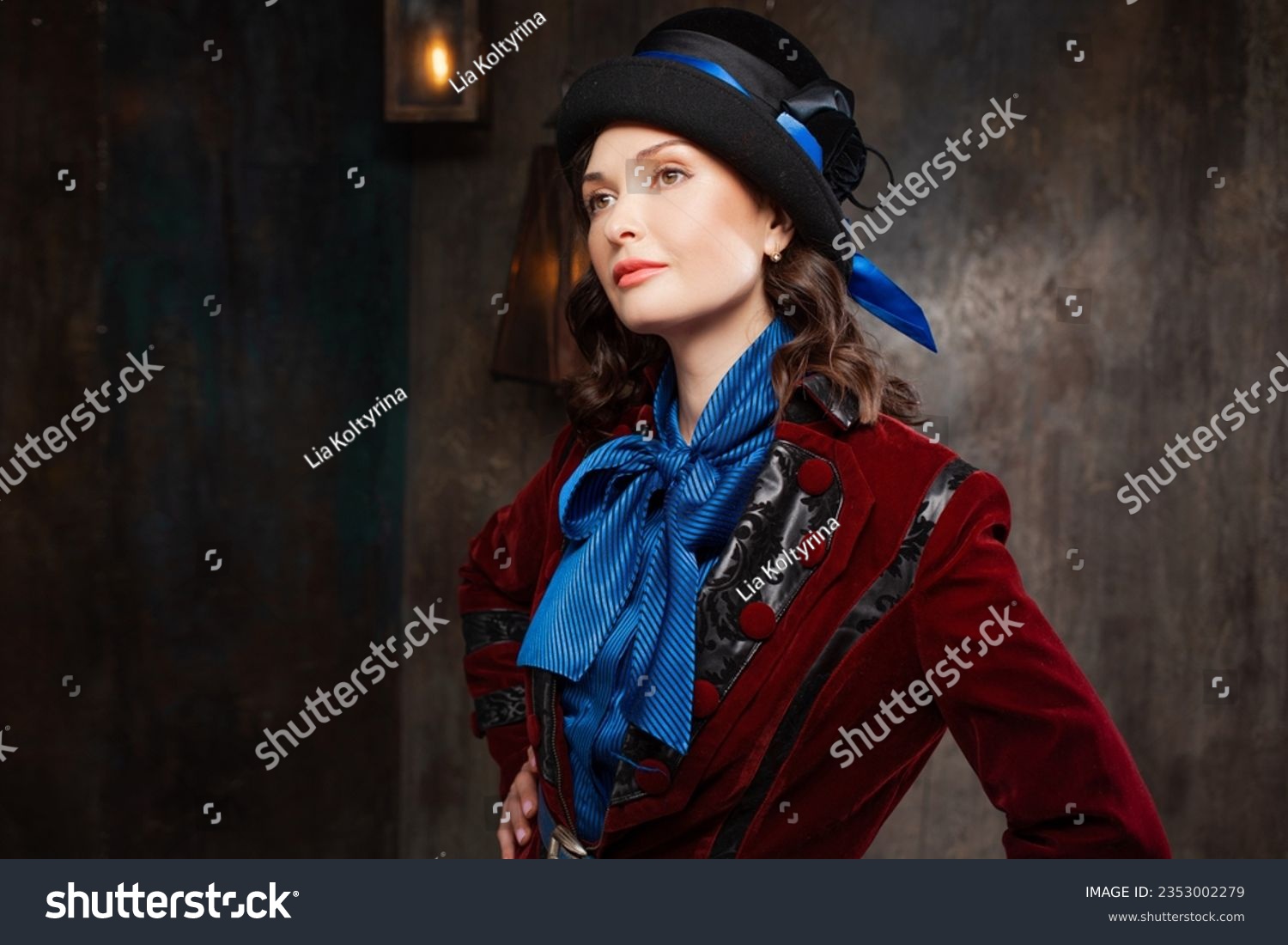 A stylish lady in a burgundy old - fashioned suit with a hat . Brunette in a retro style suit #2353002279