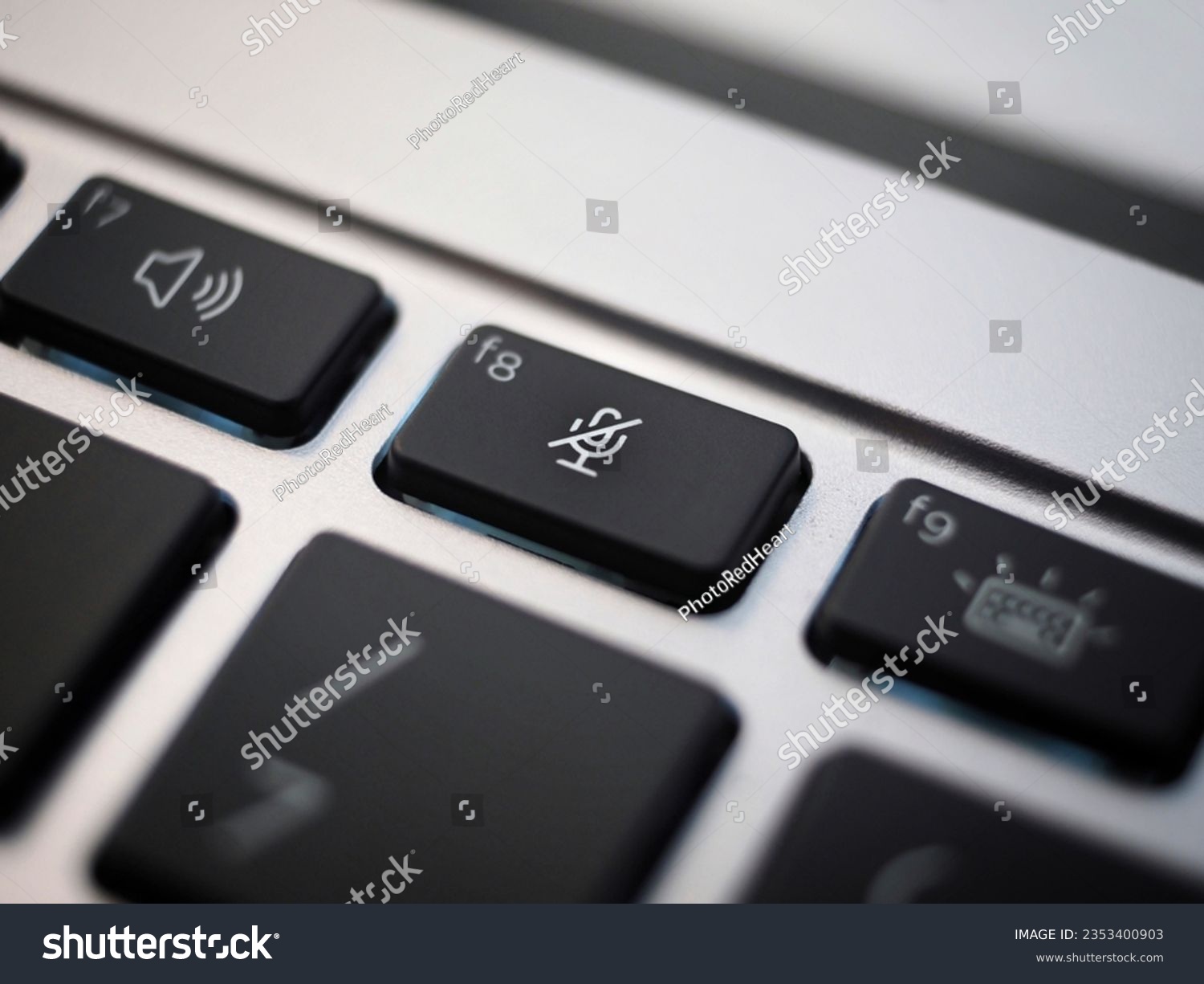 balck mute key closeup on a laptop keayboard #2353400903