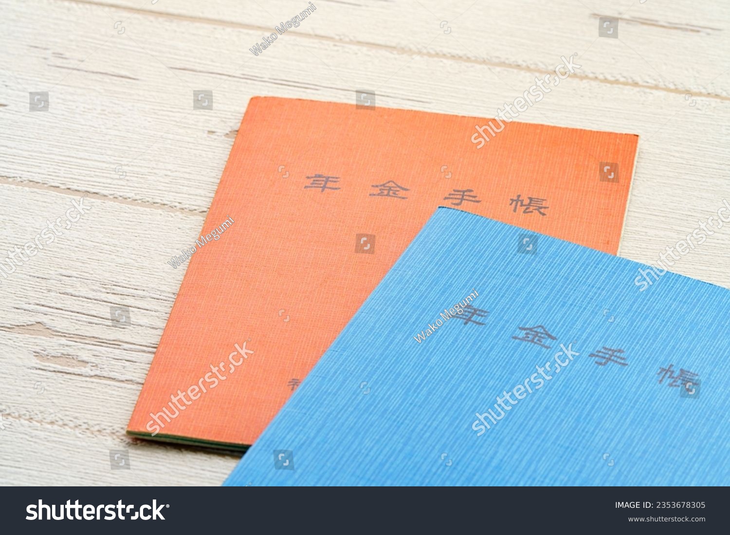 Japanese pension insurance booklet on wooden table. (Written 'pension book') #2353678305