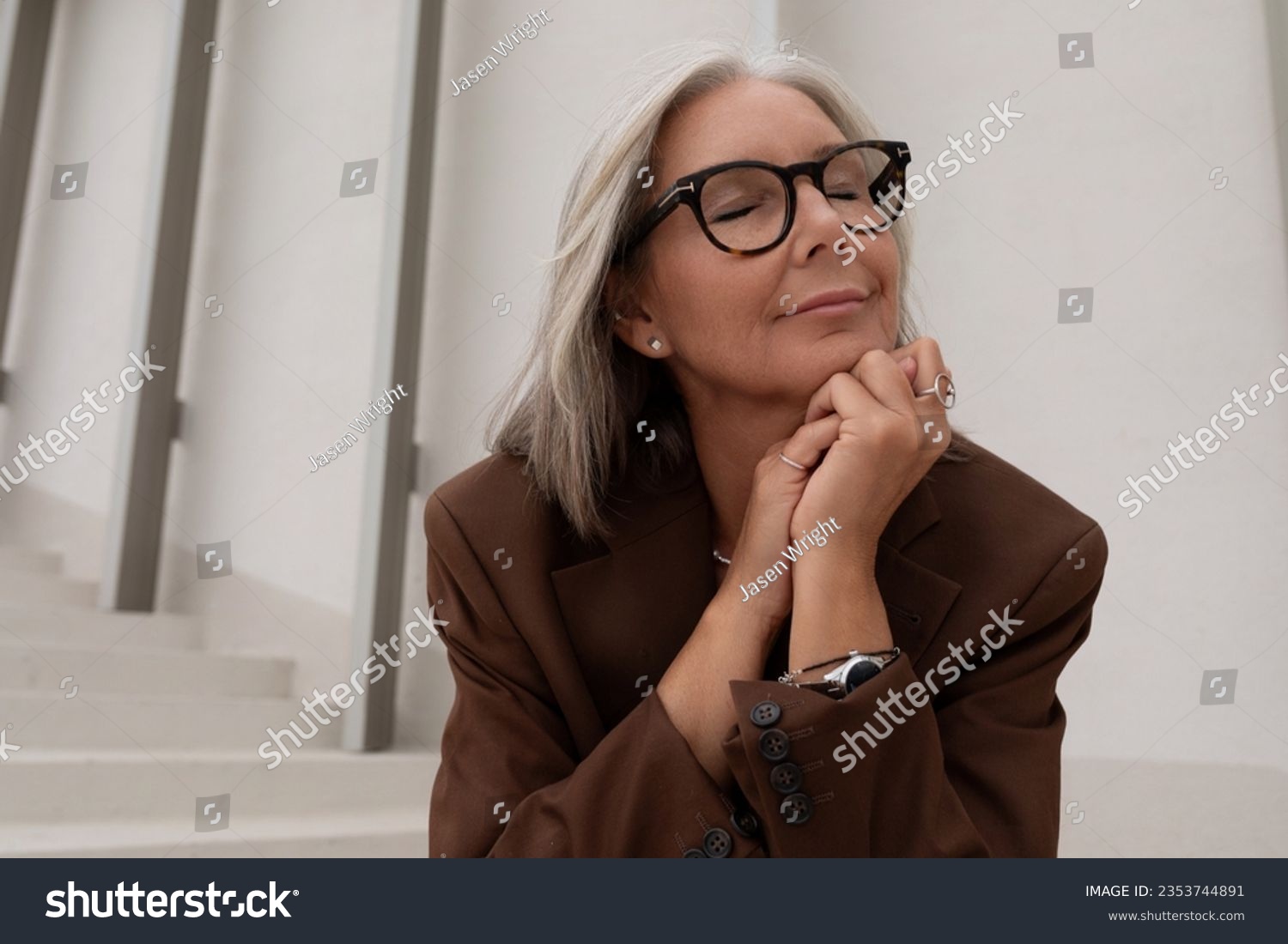 a gray-haired middle-aged woman with a bob haircut is dressed in a jacket and trousers enjoying freedom on the street #2353744891