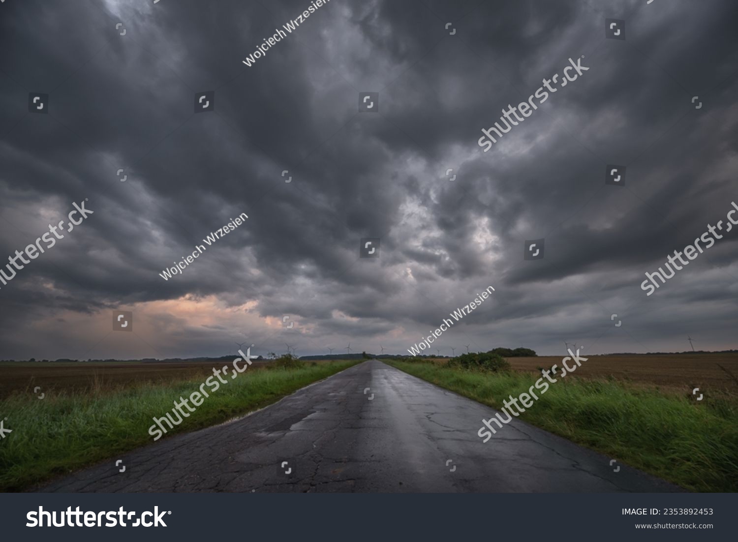 WEATHER - Dramatic black rain clouds over fields and country road #2353892453