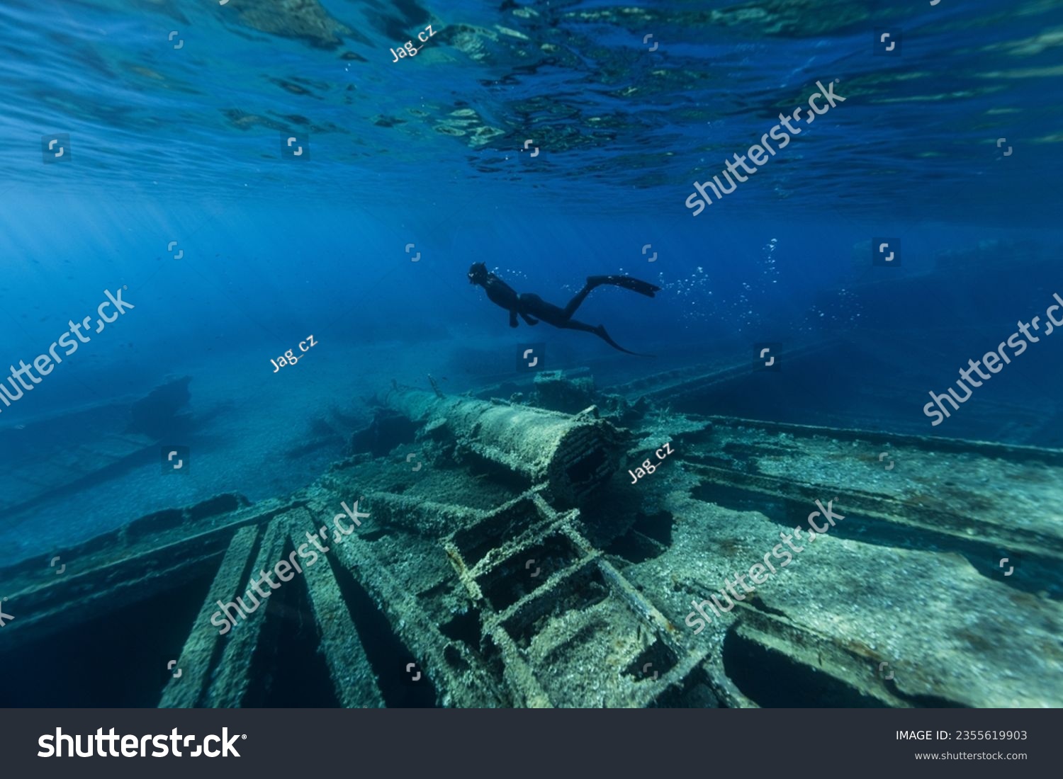 Freediver Swimming in Deep Sea and Exploring Ship Wreck. Young Man Diver Eploring Sea Life. #2355619903