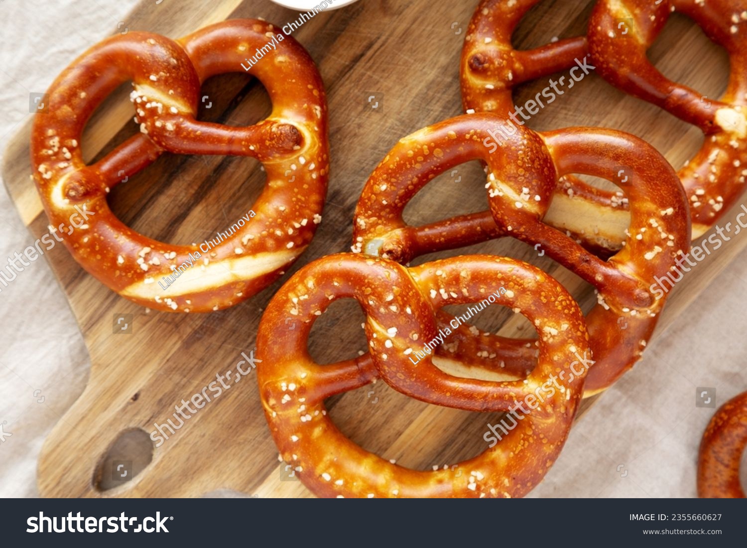 Homemade Soft Bavarian Pretzels with Mustard on a wooden board, top view. #2355660627