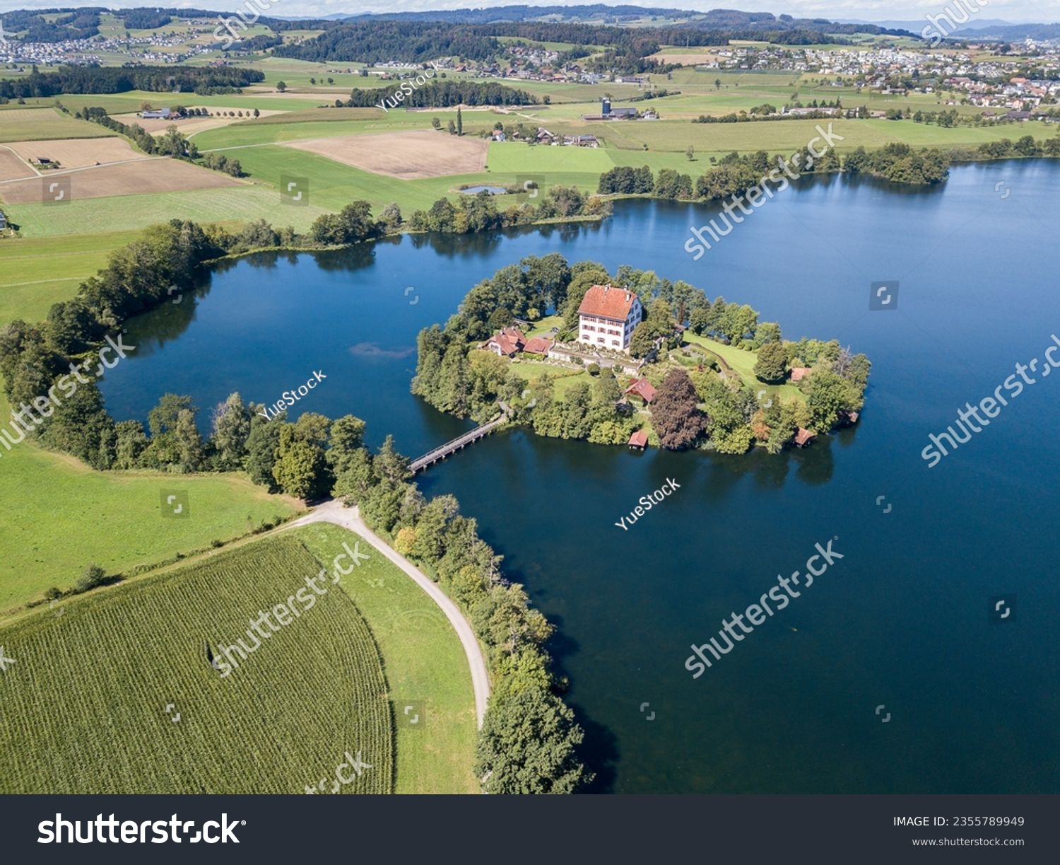 Aerial view of the Mauern Lake with an old, little castle on the small island #2355789949
