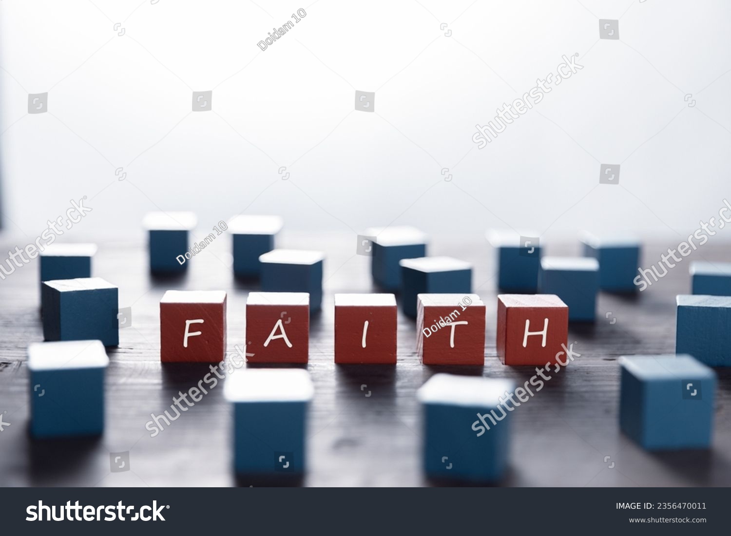 Faith symbol. Turned wooden cube with words Faith. Beautiful white background. Business and Faith concept. Copy space #2356470011