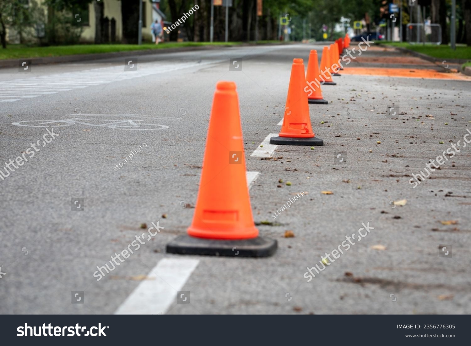 Orange traffic cones on the road. Urban environment. #2356776305