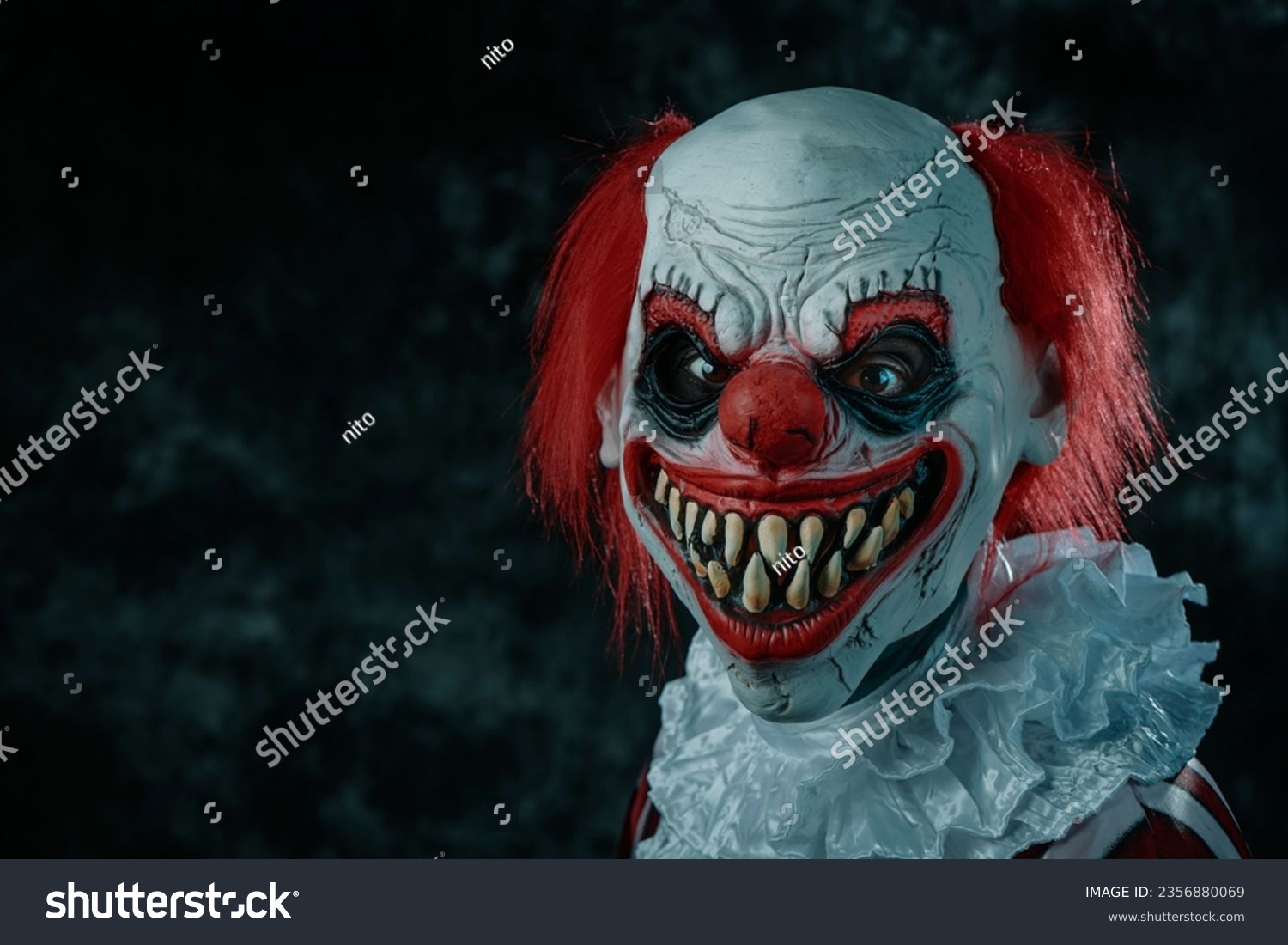 a mad evil redhead clown, wearing a white and red striped costume with a white ruff, stares at the observer with a creepy smile, in front of a dark background #2356880069