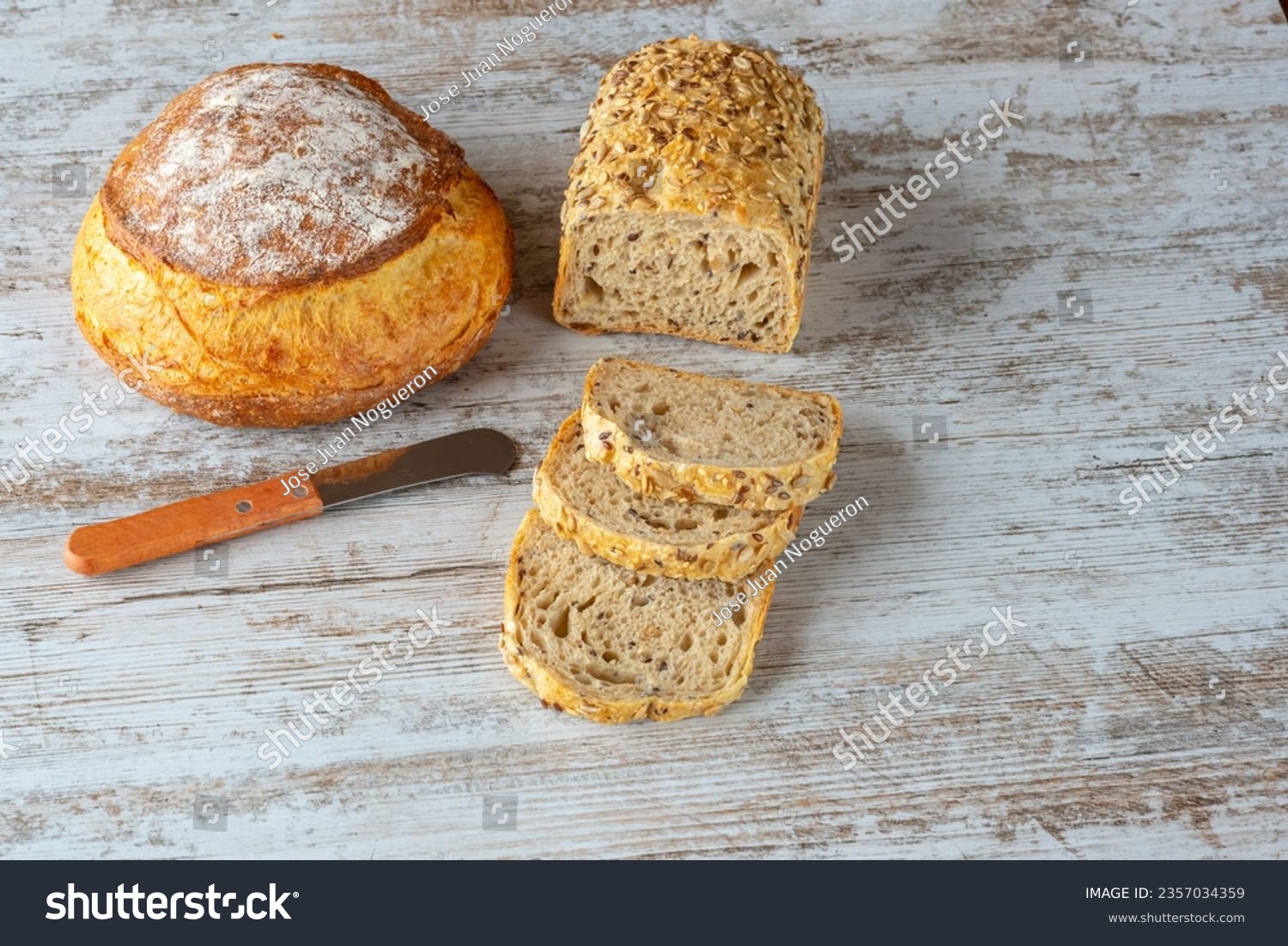 Different types of bread cut into slices and whole #2357034359