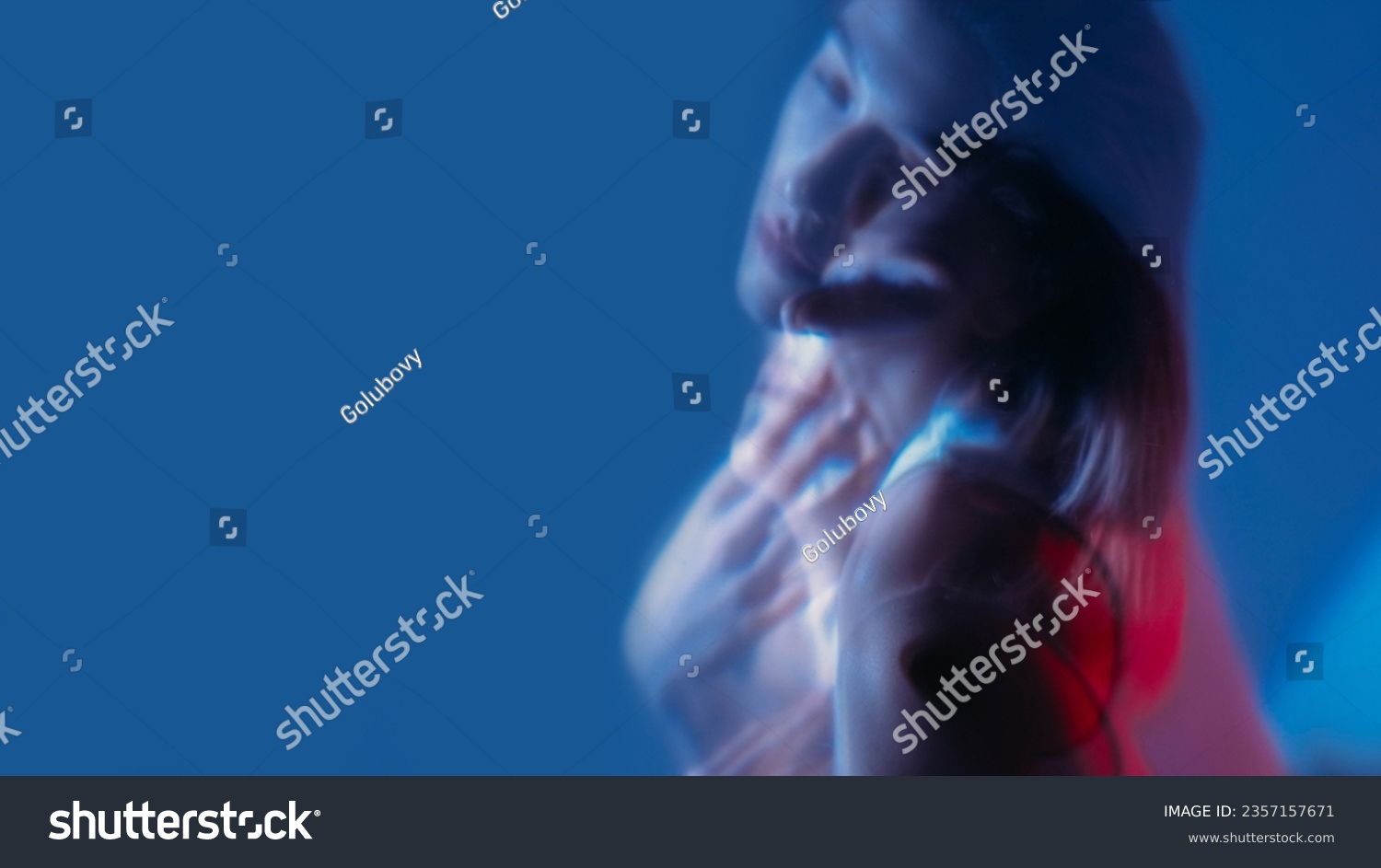 Depressed face. Color light portrait. Double exposure of unhappy unsmiling woman with soul pain isolated on neon blue empty space background. #2357157671