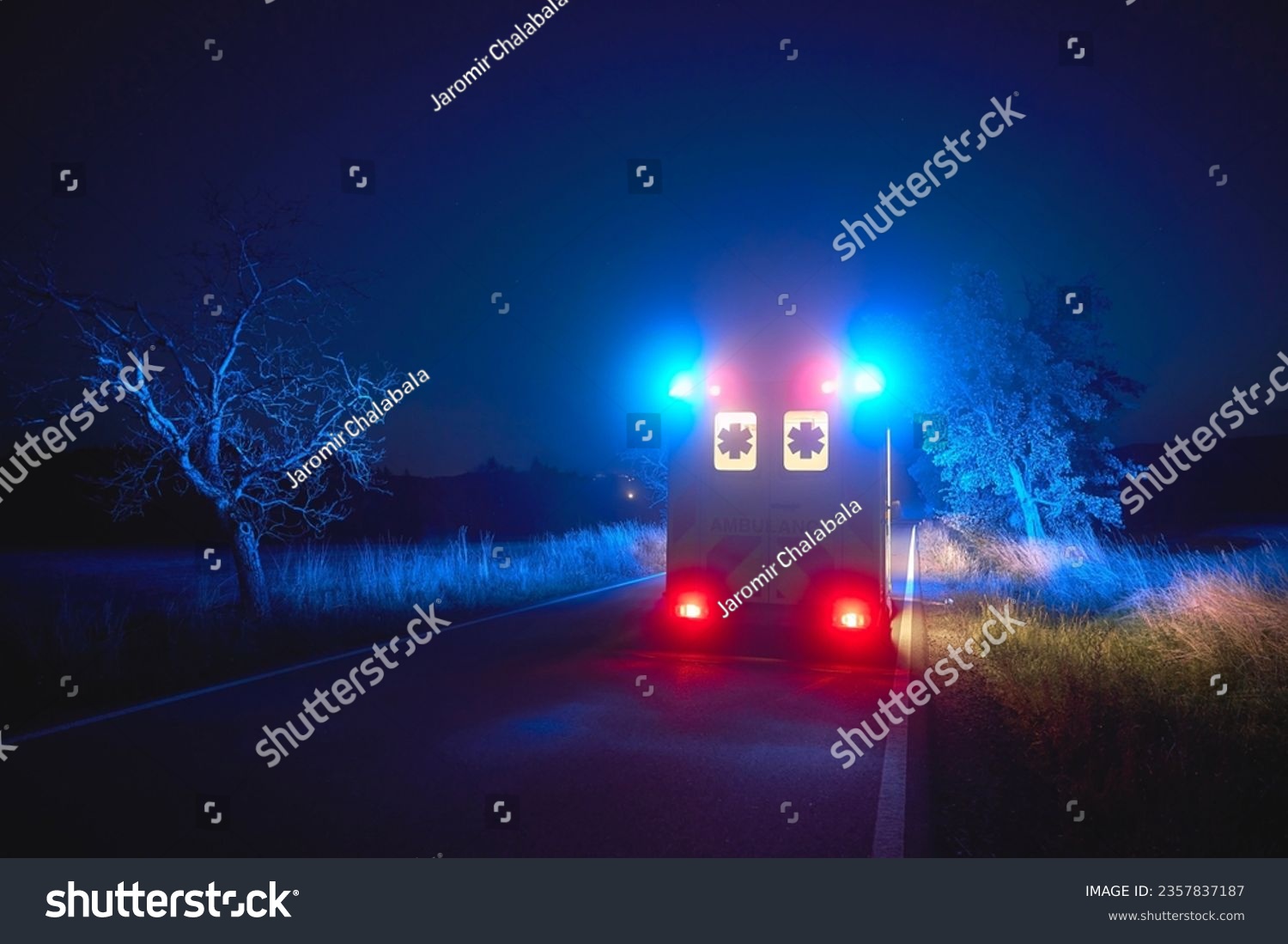 Ambulance car of emergency medical service on road at night. Themes rescue, urgency and health care. 
 #2357837187