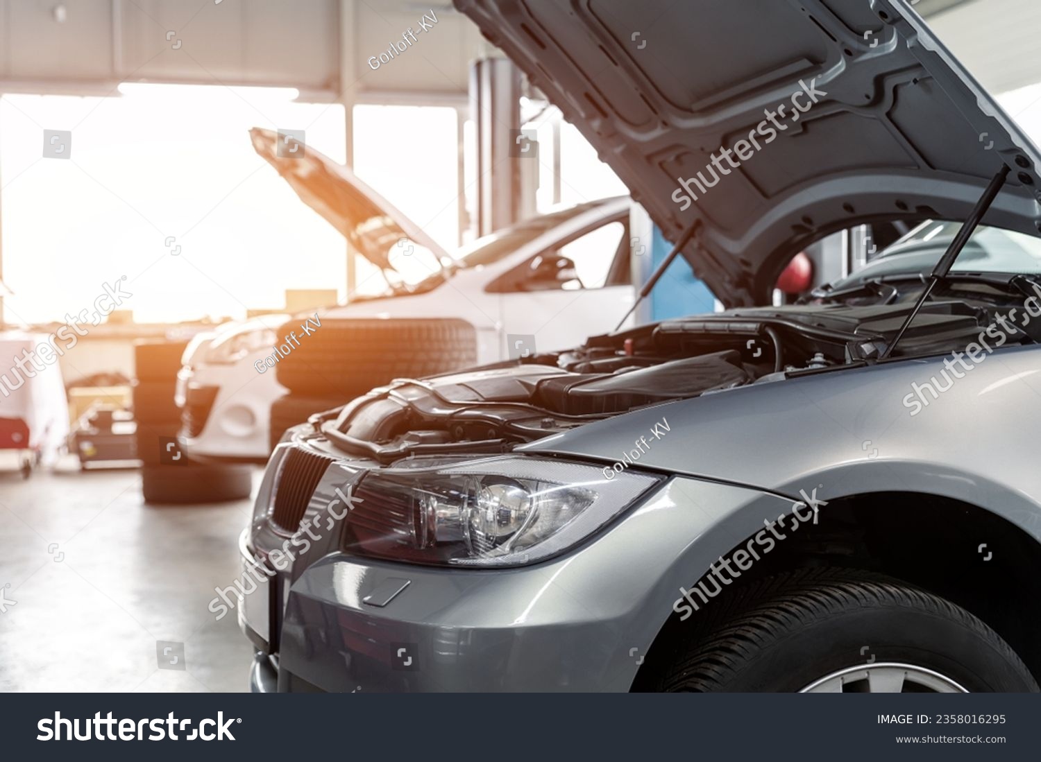 Car service center garage workshop. Vehicle raised on lift at maintenance station. Automobile repair and check up. Automotive insurance and technical checkup inspection diagnostic #2358016295