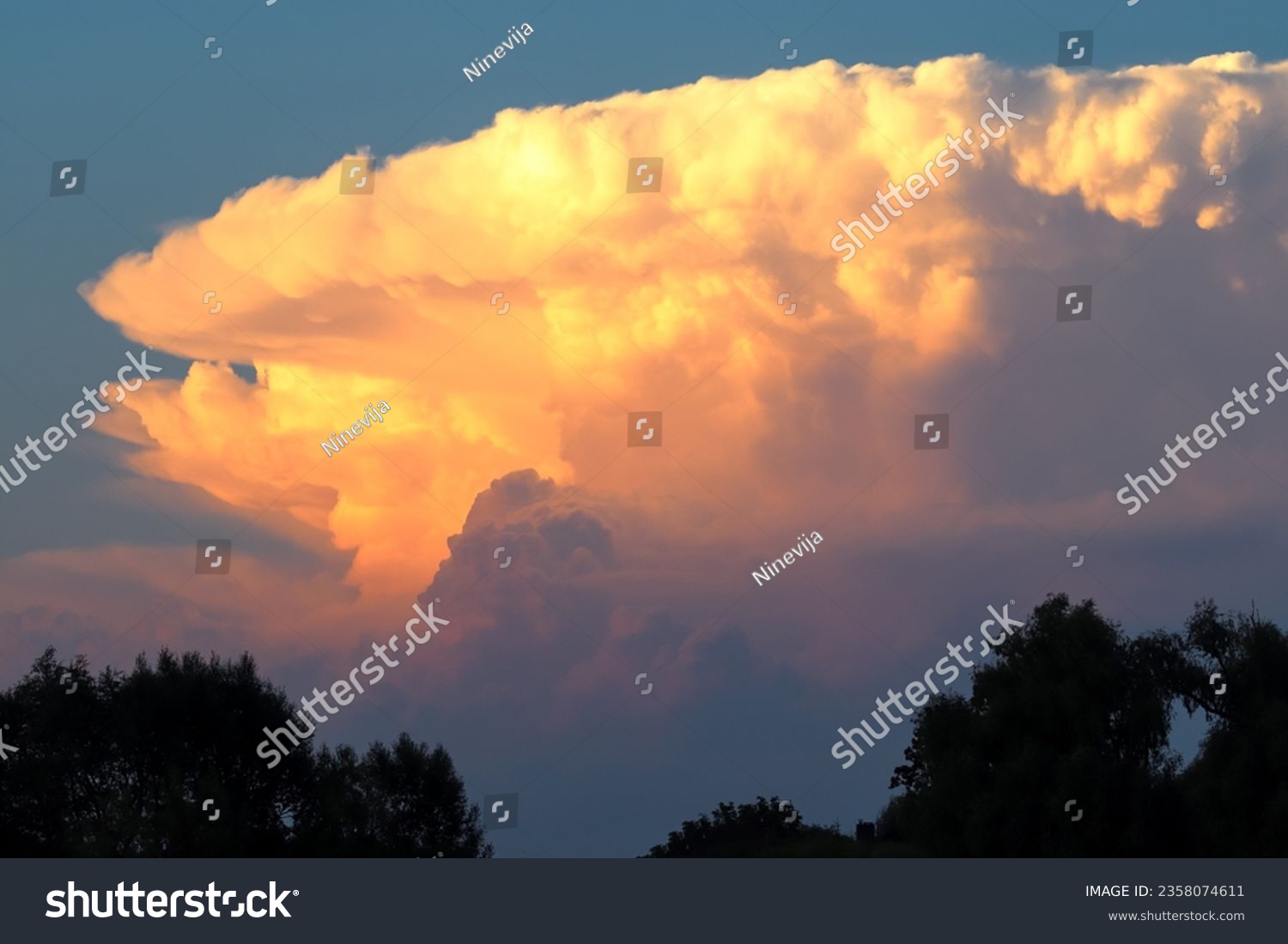 Colorful cumulonimbus cloud at sunset. Evening #2358074611