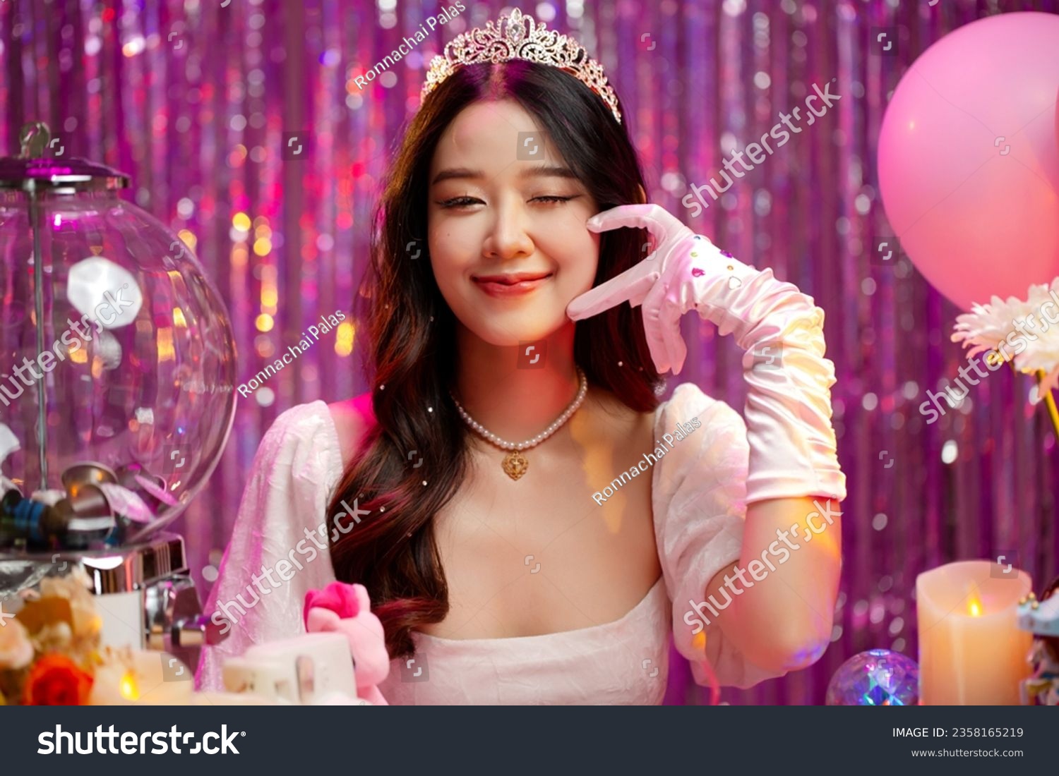 Happy beautiful Asian girl in princess dress showing birthday cake. Birthday princess photography theme is popular in Asia. #2358165219