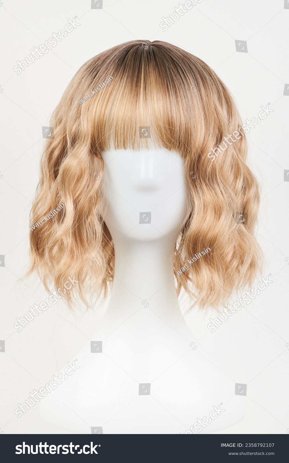 Natural looking blonde fair wig on white mannequin head. Middle length hair cut on the plastic wig holder isolated on white background, front view
 #2358792107