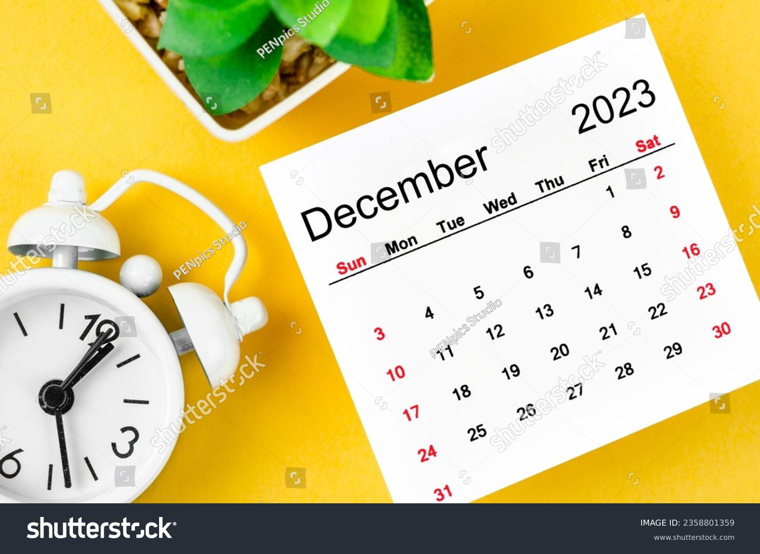 December 2023 Monthly calendar for 2023 year with alarm clock on yellow background. #2358801359