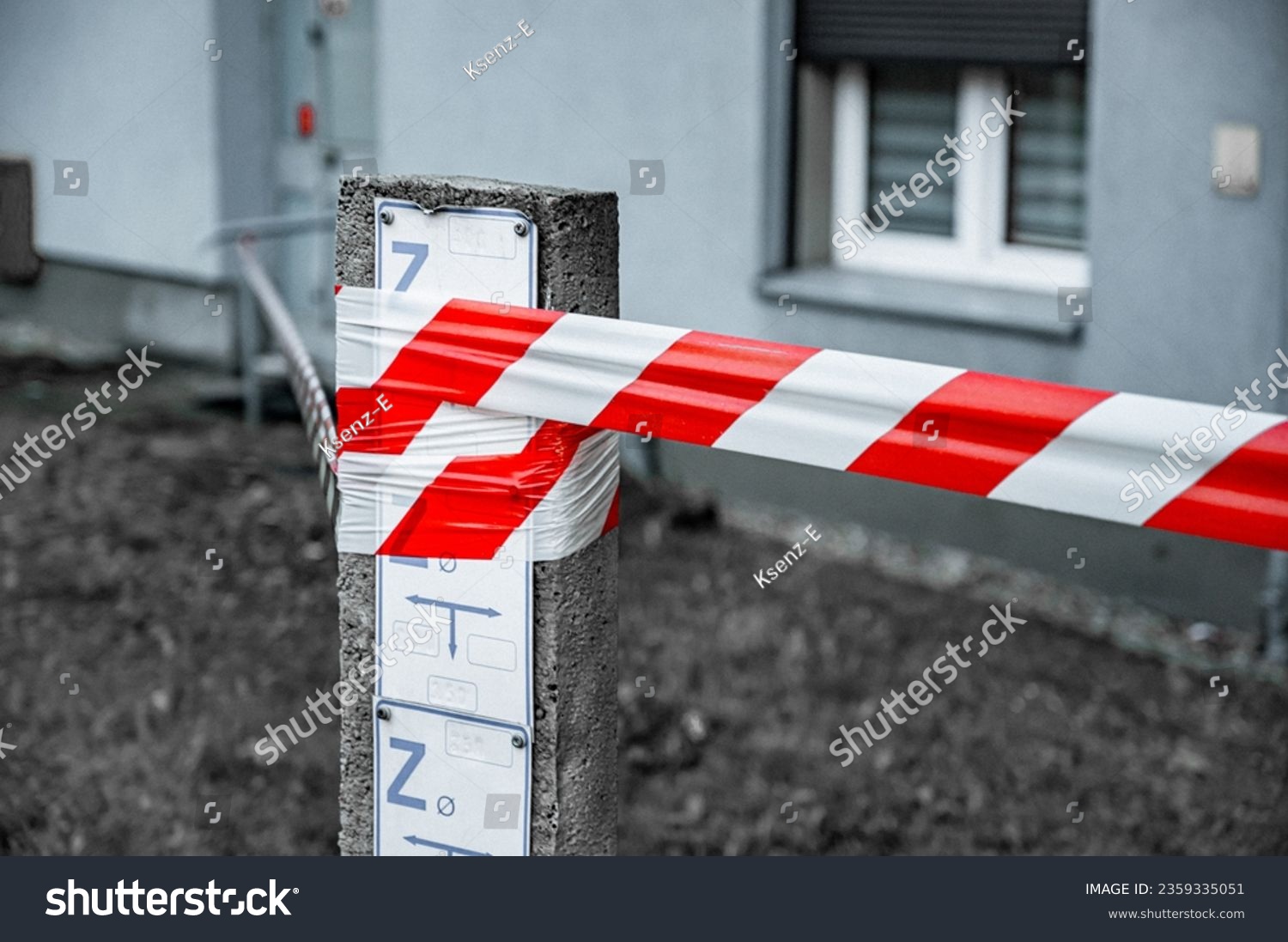 Red and White Lines of barrier tape. at street background. Red White warning tape pole fencing is protects for No entry #2359335051