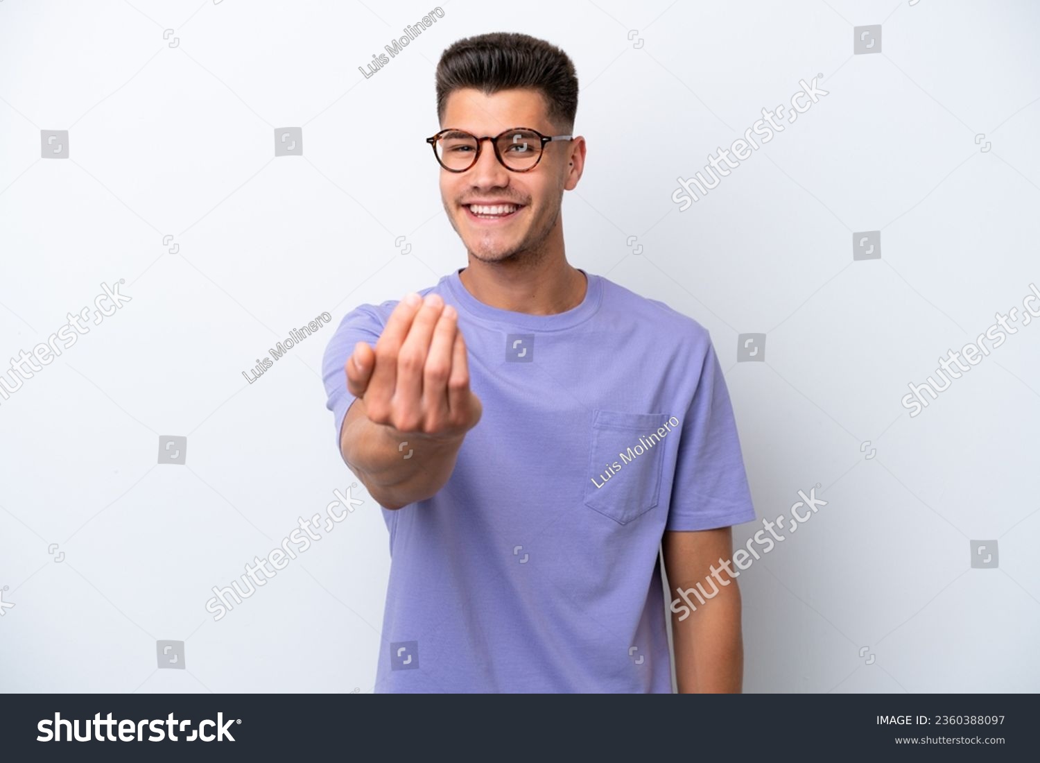Young caucasian man isolated on white background inviting to come with hand. Happy that you came #2360388097