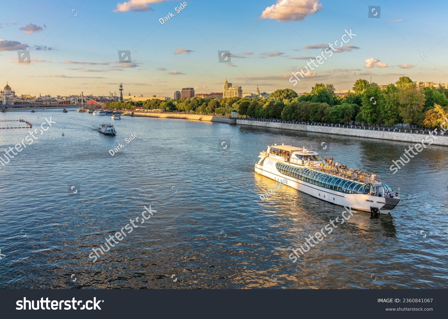Cruise ship sails on the Moscow river in Moscow city center, popular place for walking. Panoramic view of Moscow river with cruise boat #2360841067