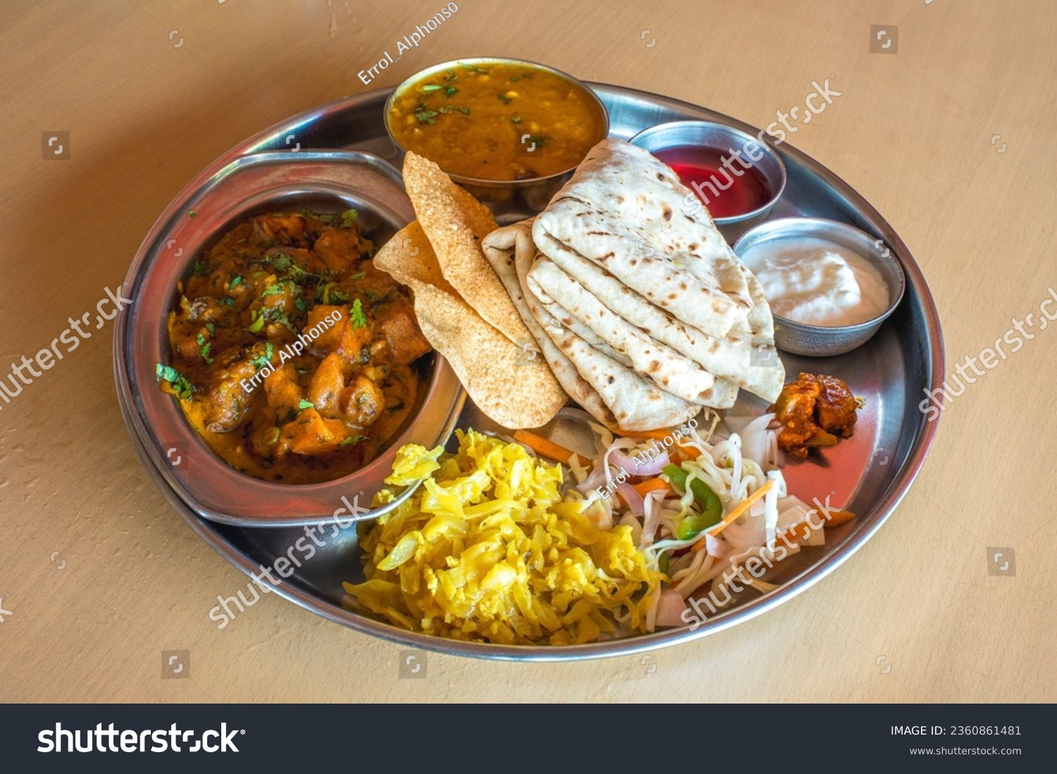 Shot of healthy and tasty Indian vegetarian Lunch dinner platter with many variety of appetising vegetarian dishes to tangle your taste buds and give you a complete meal satisfaction #2360861481