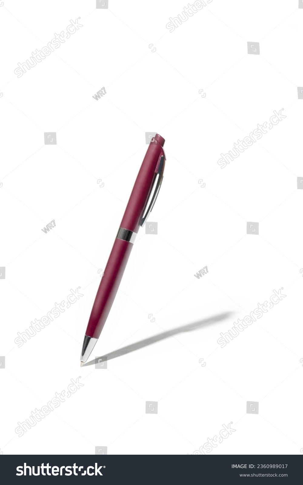 Detailed purple classic ballpoint pen writing on white surface with its shadow. Isolated on white background with clipping path #2360989017