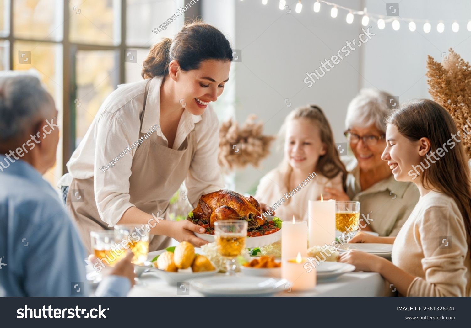 Thanksgiving Day, Autumn feast. Happy family sitting at the table and celebrating holiday. Grandparents, mother and children. Traditional dinner. #2361326241