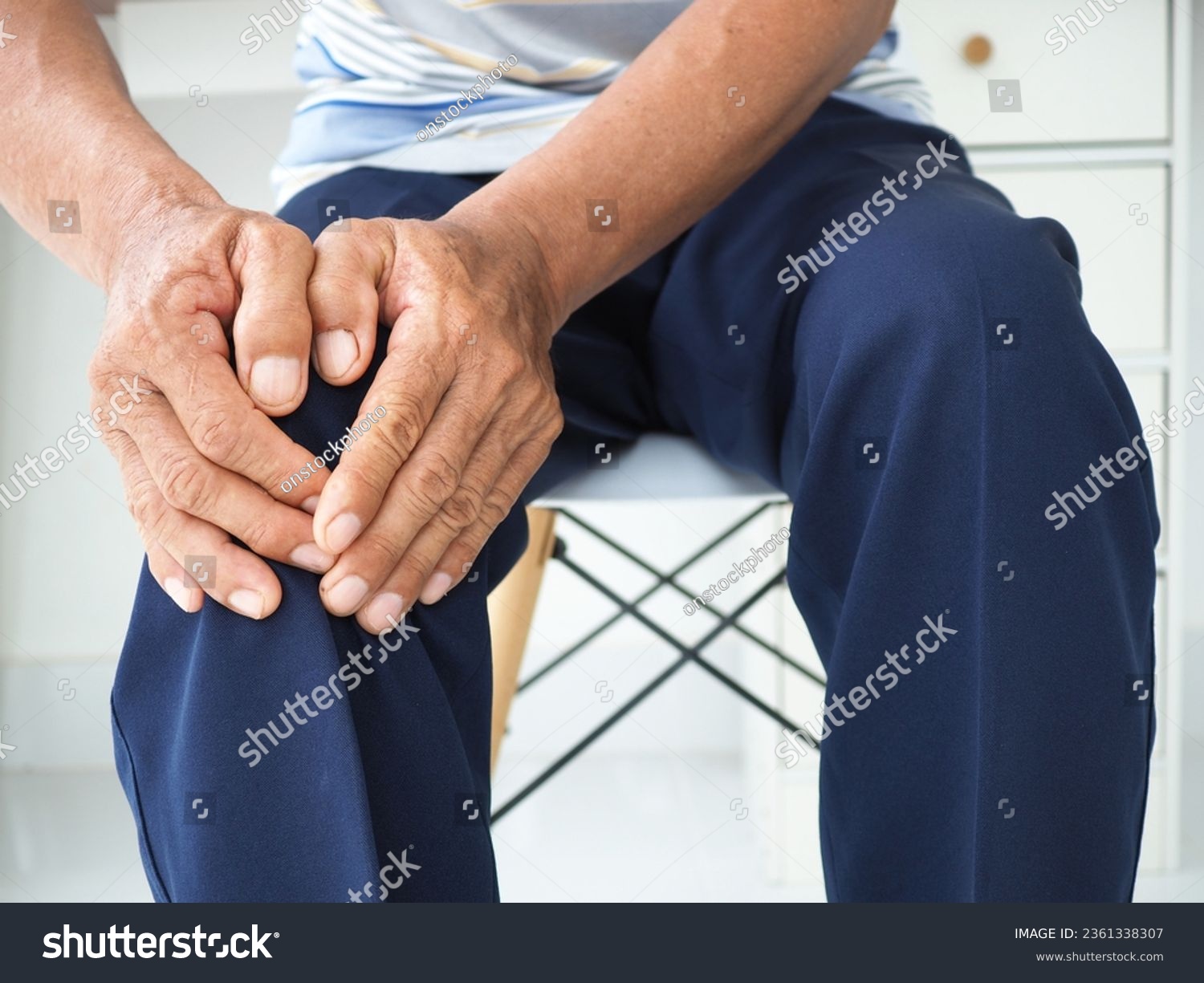 Asian man in suffering from knee pain at home, Health concept. #2361338307