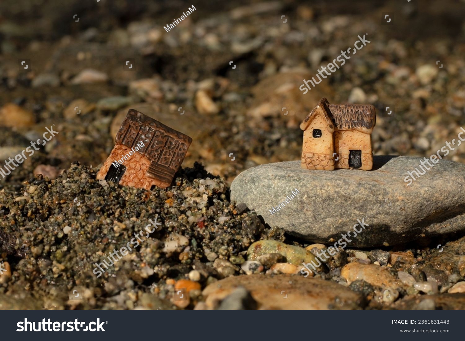 Two miniature houses in sand and on rock (stone). Close-up. Wise and solid foundation gospel parable of Jesus Christ, obedience, and faith in God. Christian biblical concept. #2361631443