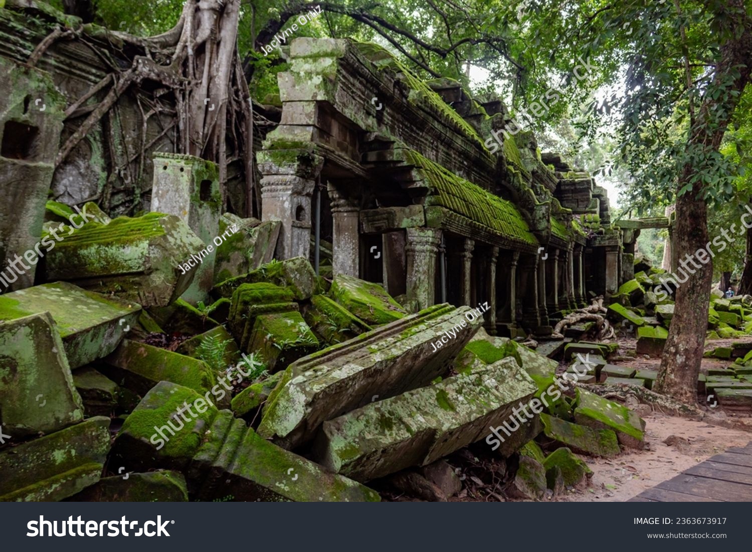 Green moss-covered stone brick building ruins at Ta Prohm Tomb Raider temple complex. Angkor Wat historical site, Siem Reap, Cambodia #2363673917