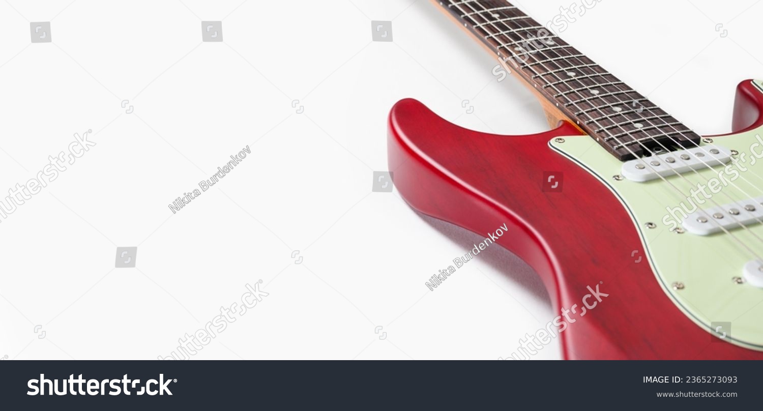 Part of an electric guitar on a white background. Free space. Selective focus on the fretboard. #2365273093