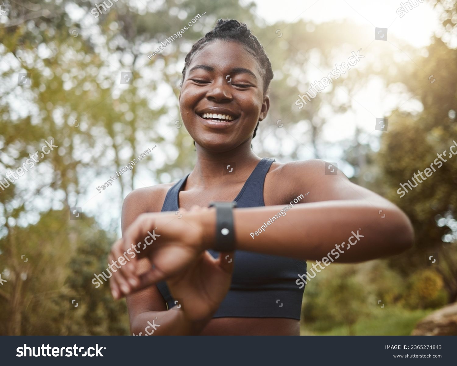 African runner woman, smart watch and park for check, smile or happy for time, results or fitness in nature. Girl, iot clock and monitor for speed, heart rate or smile for exercise, workout or health #2365274843