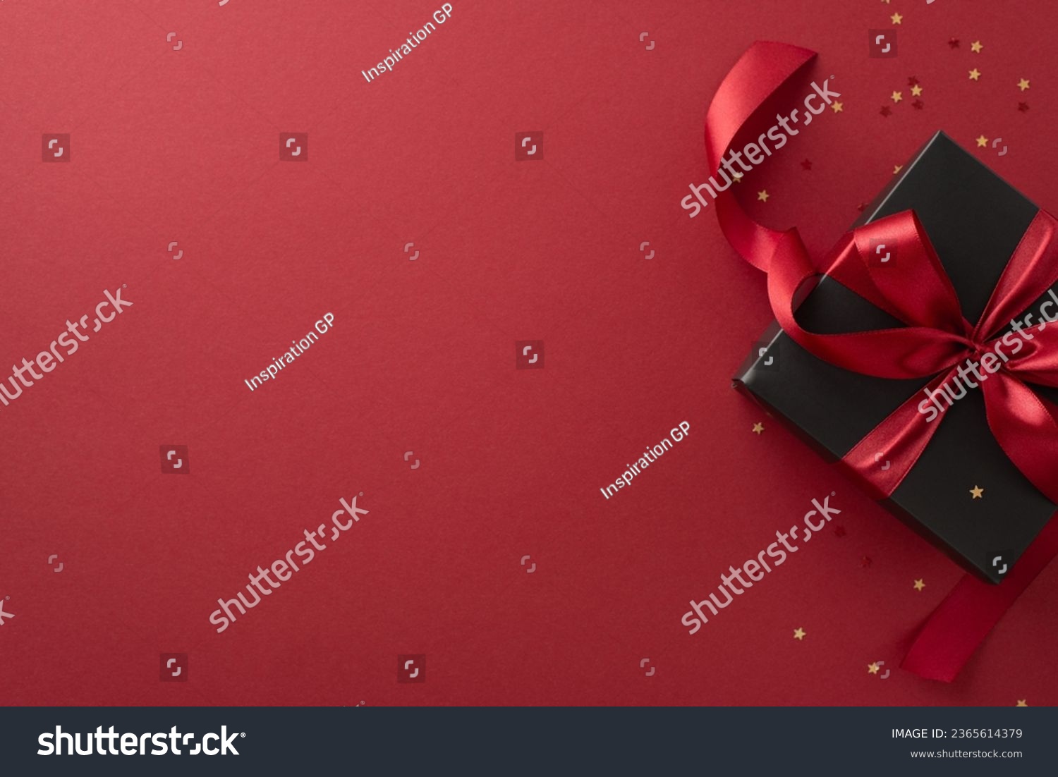 Festive Black Friday surprise! Top view black gift box, adorned with vibrant red ribbon, surrounded by golden star-shaped confetti, set against rich marsala backdrop. Ideal for your Black Friday deals #2365614379