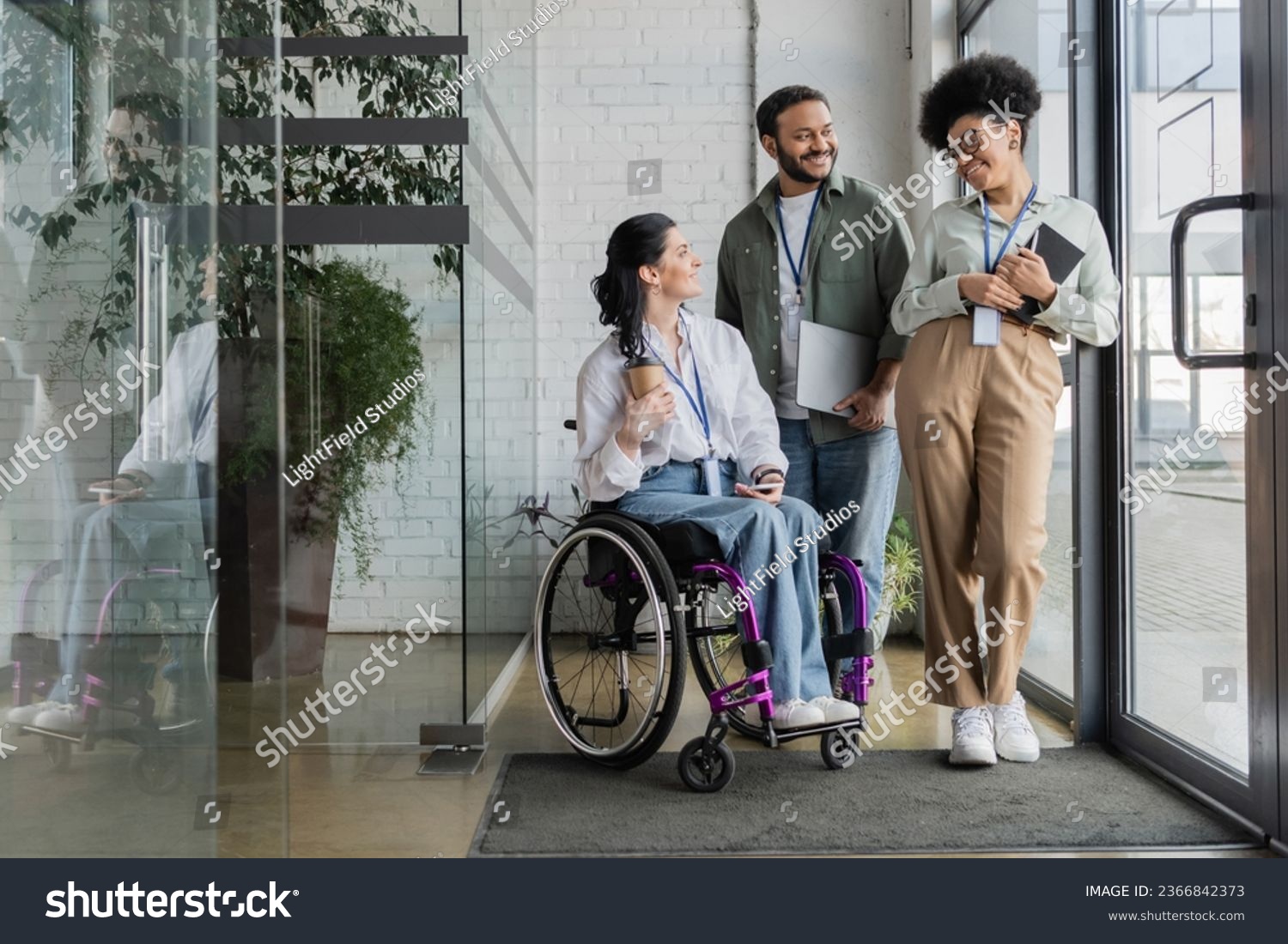 group shot of diverse business people, disabled woman on wheelchair chatting with colleagues #2366842373