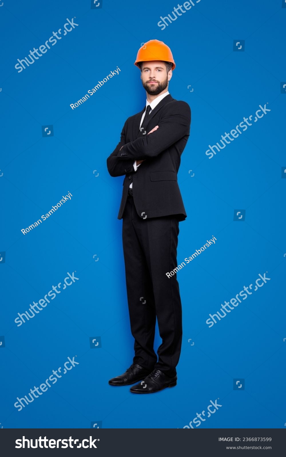 Full length size portrait of attractive beardedstylish investor in hard hat, black tux, tuxedo with tie, isolated on grey background, having his arms crossed #2366873599